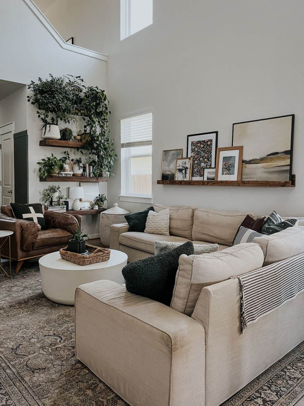 Neutral living room with art and plant shelves