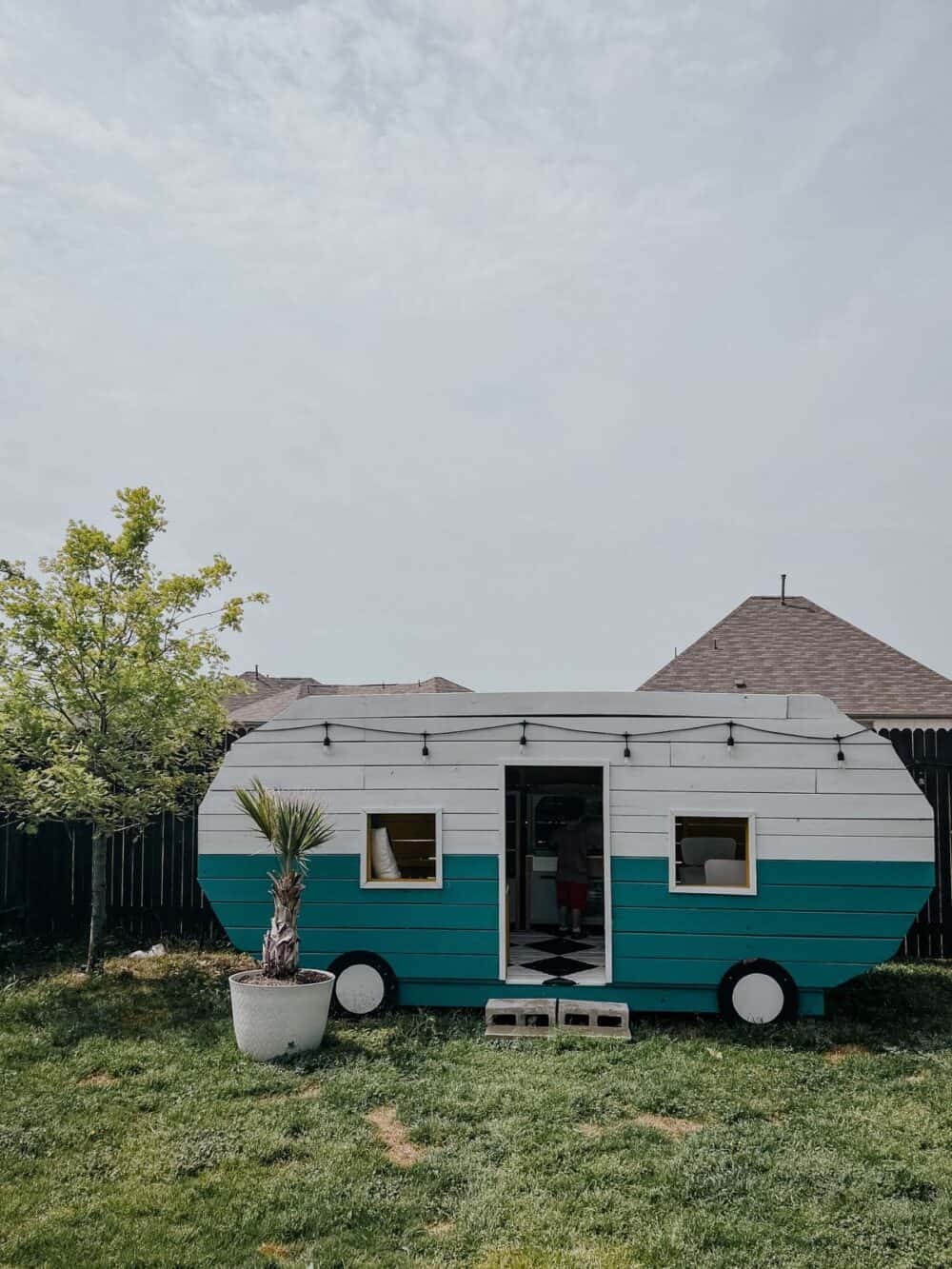 a really unique backyard playhouse in the shape of a vintage camper 