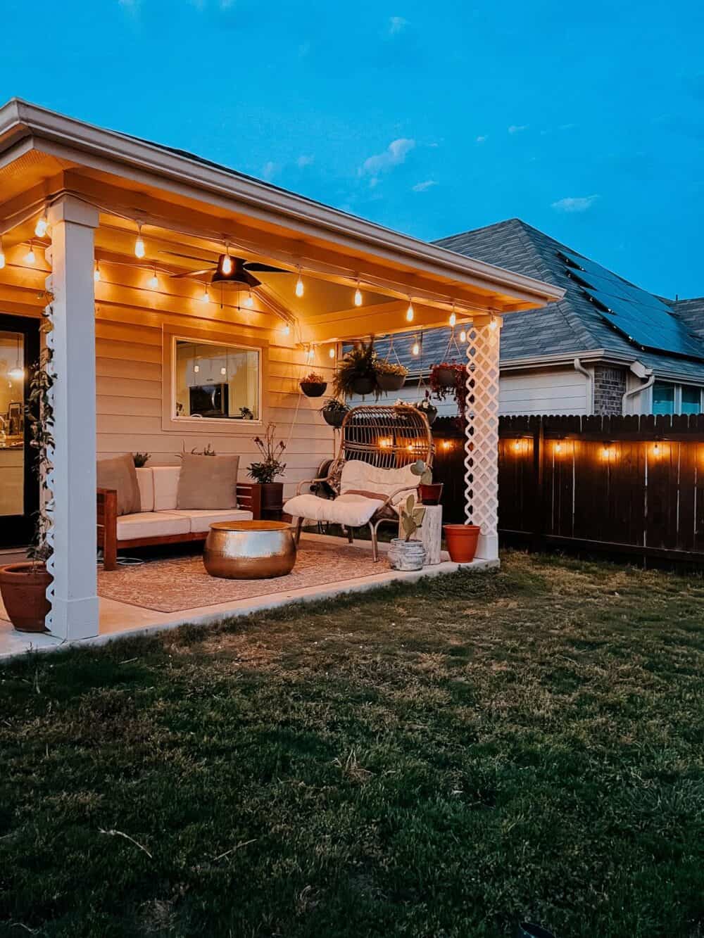 Back patio with white string lights along the roof line