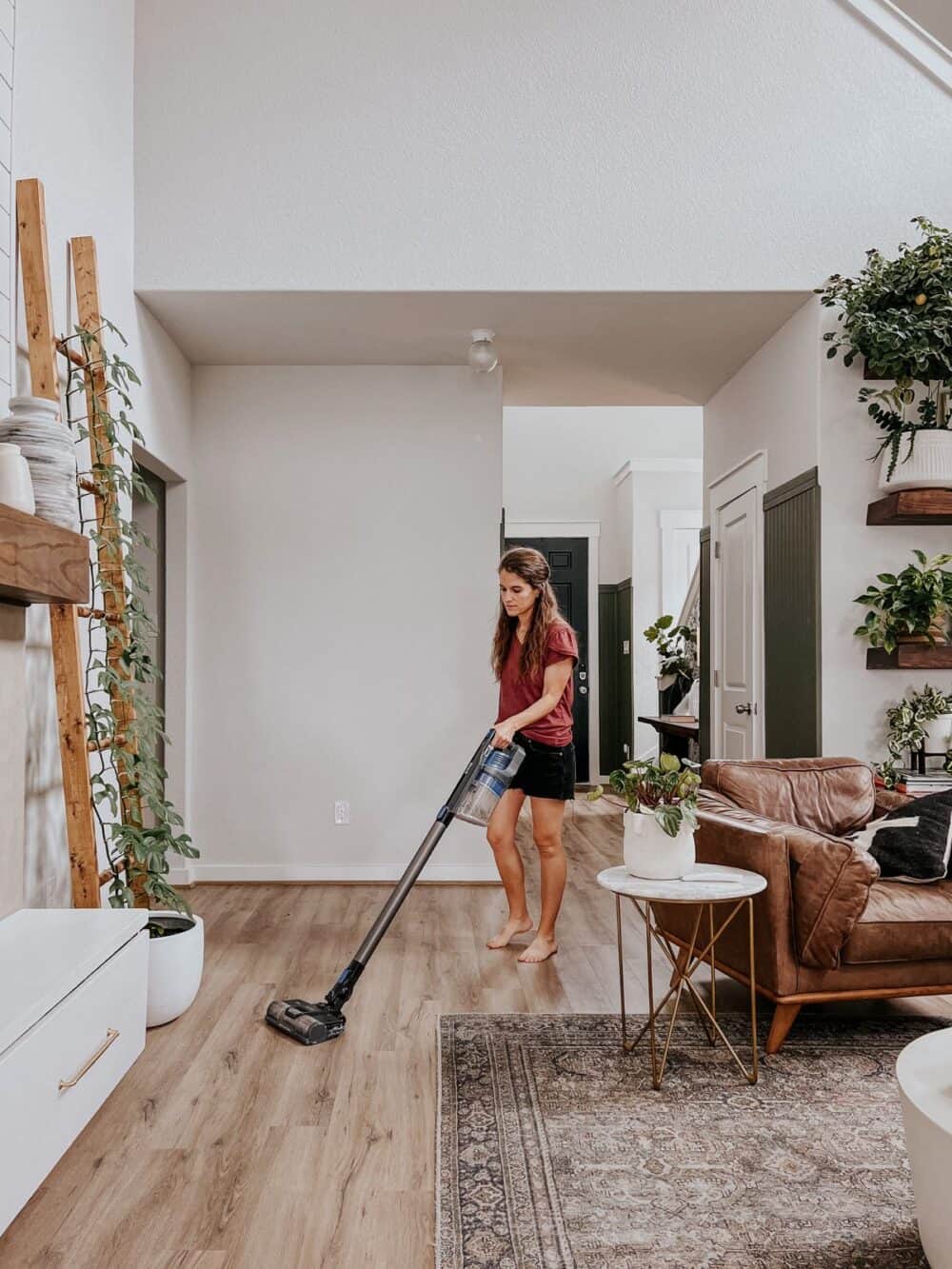 woman vacuuming vinyl plank flooring 