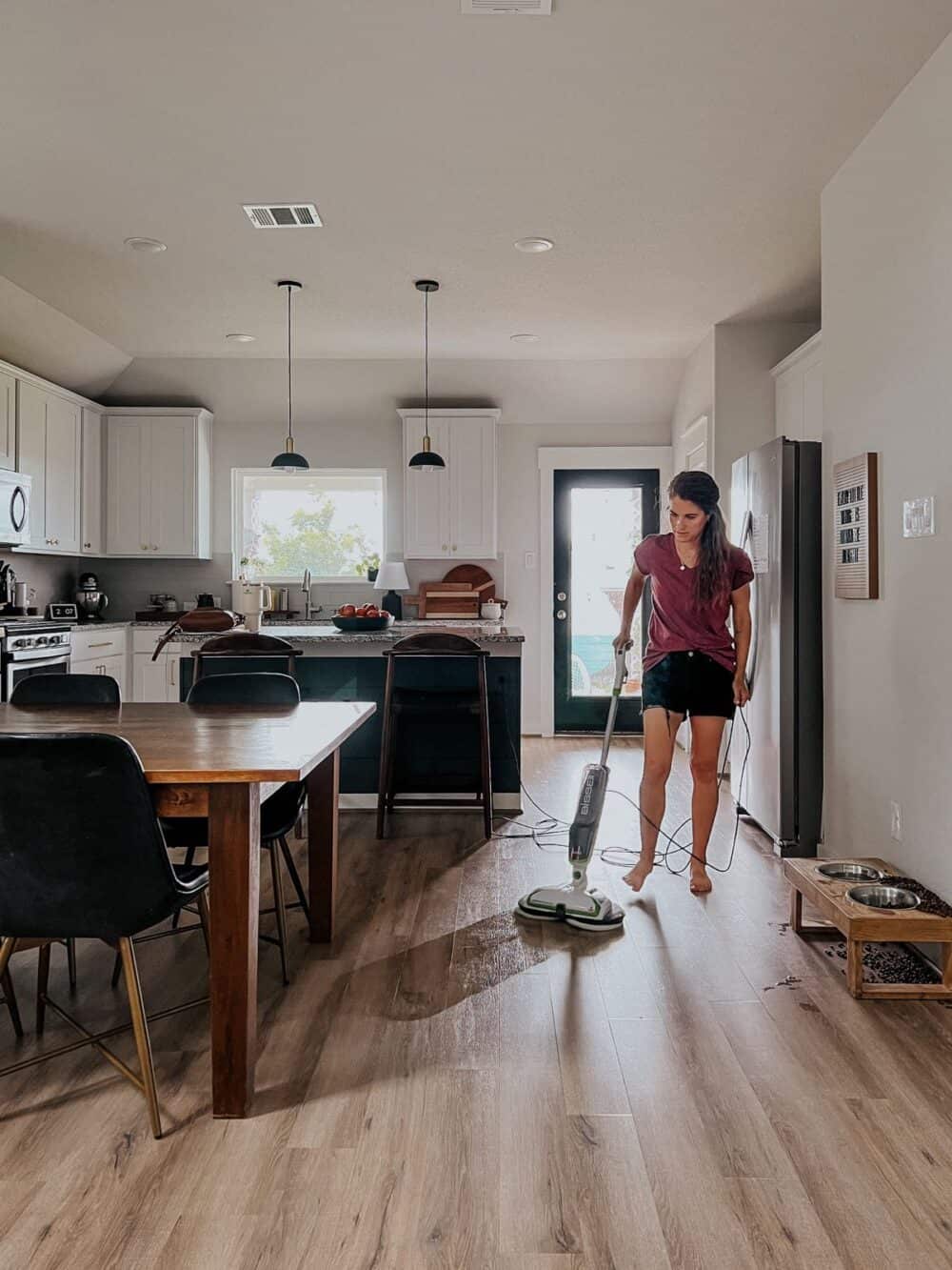 Woman mopping floor with a power mop
