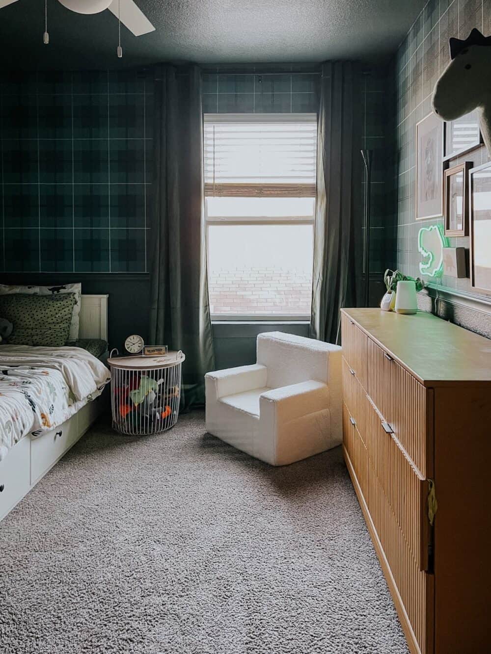 Toddler bedroom with green walls and green plaid wallpaper 