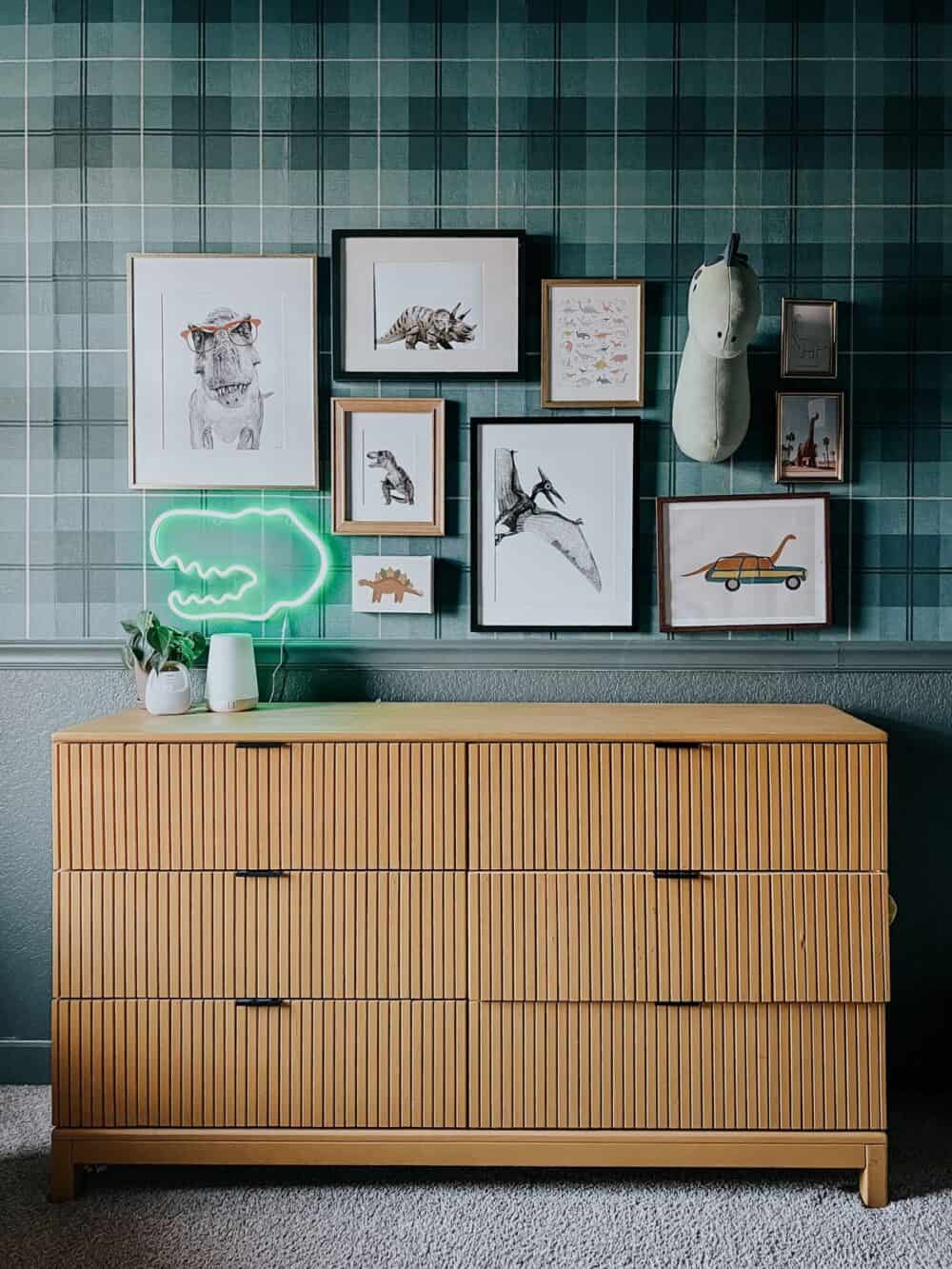 bedroom with a gallery wall above a yellow dresser 