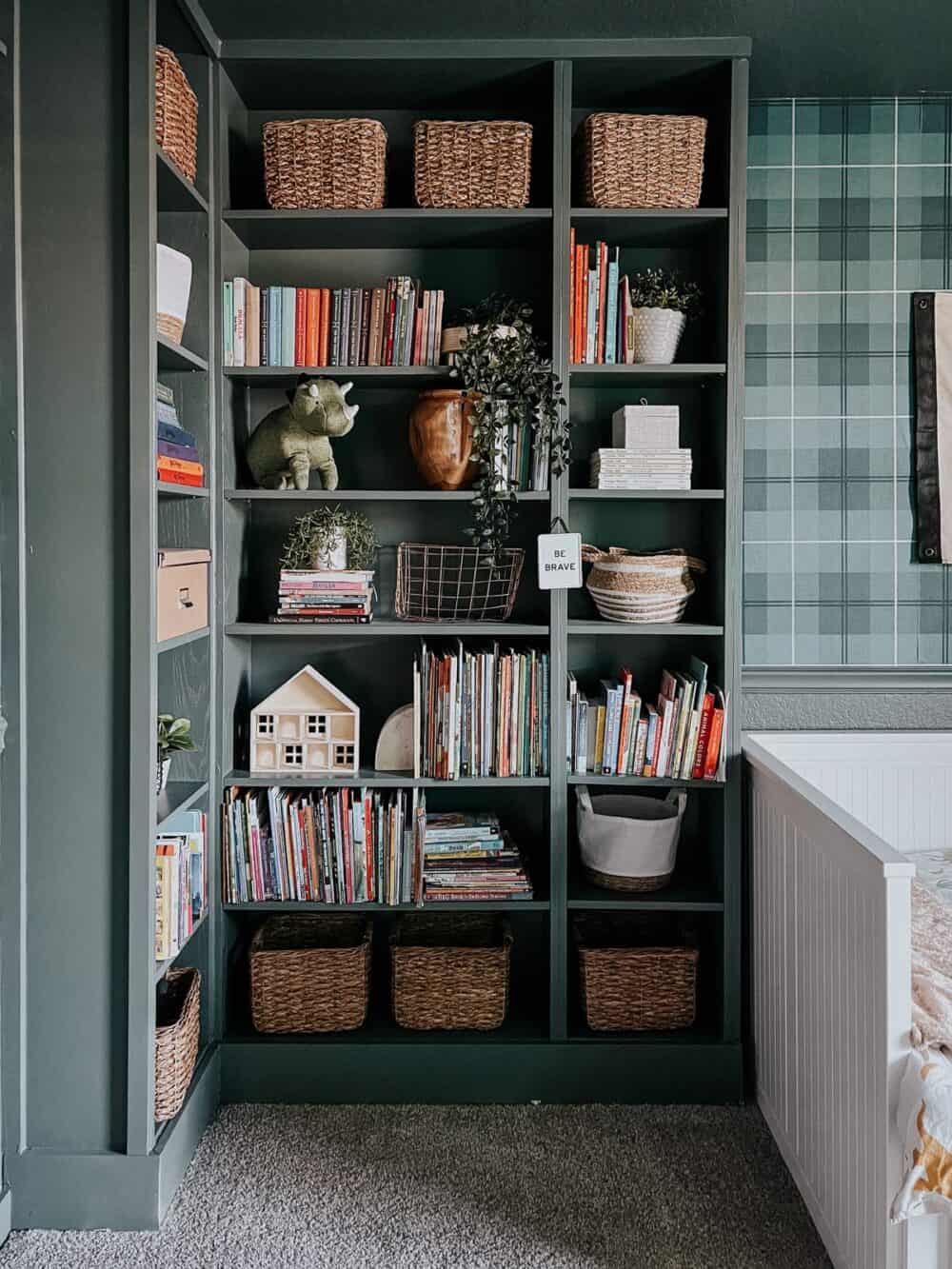 green built in shelving with baskets and books 