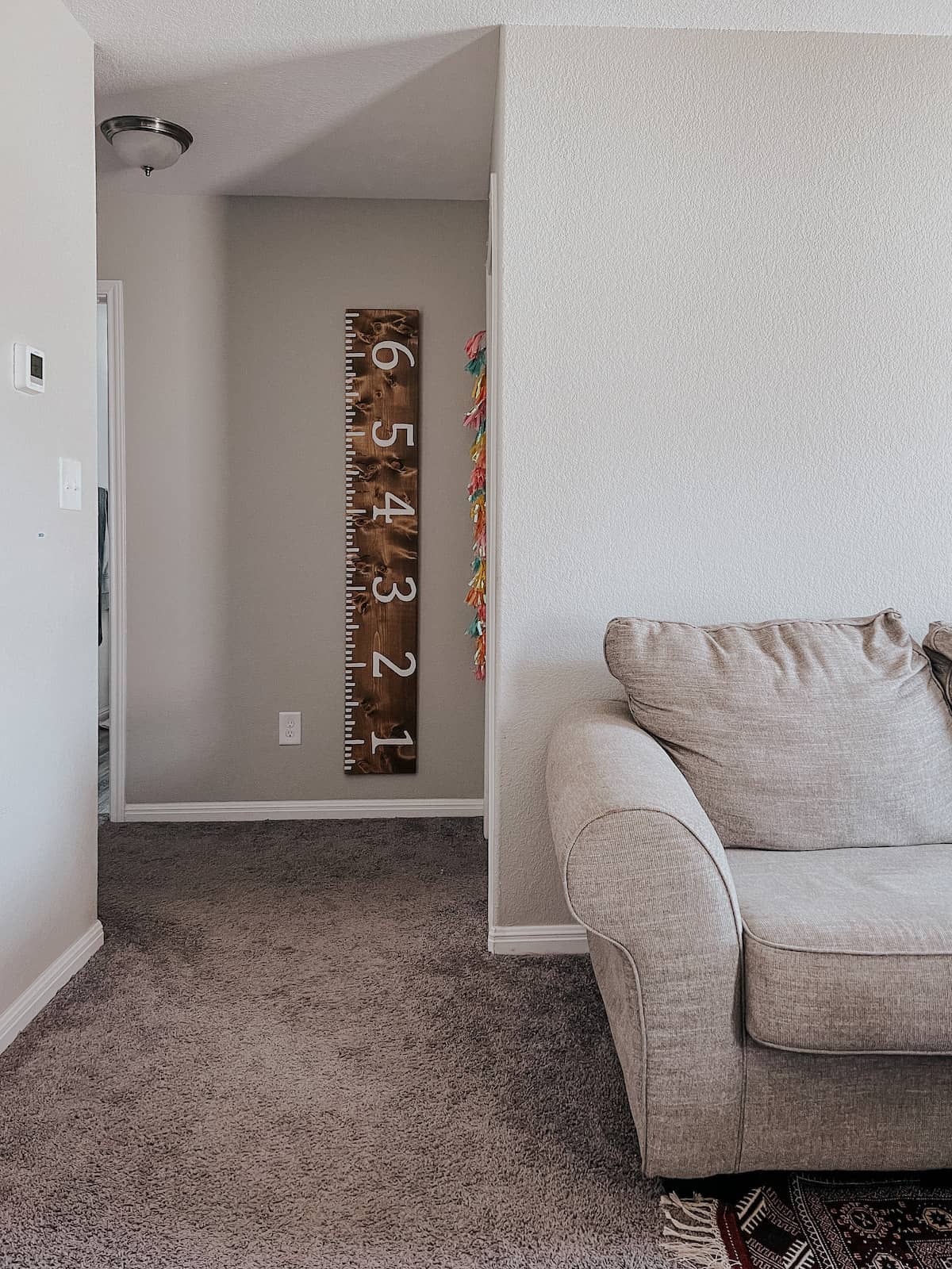 Hallway with a wooden growth chart hanging on the wall