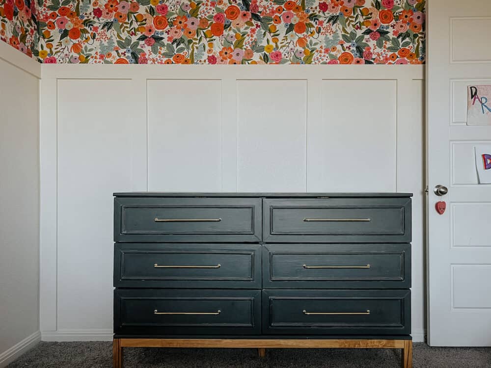 Black IKEA TARVA dresser hack against a board and batten wall with floral wallpaper 