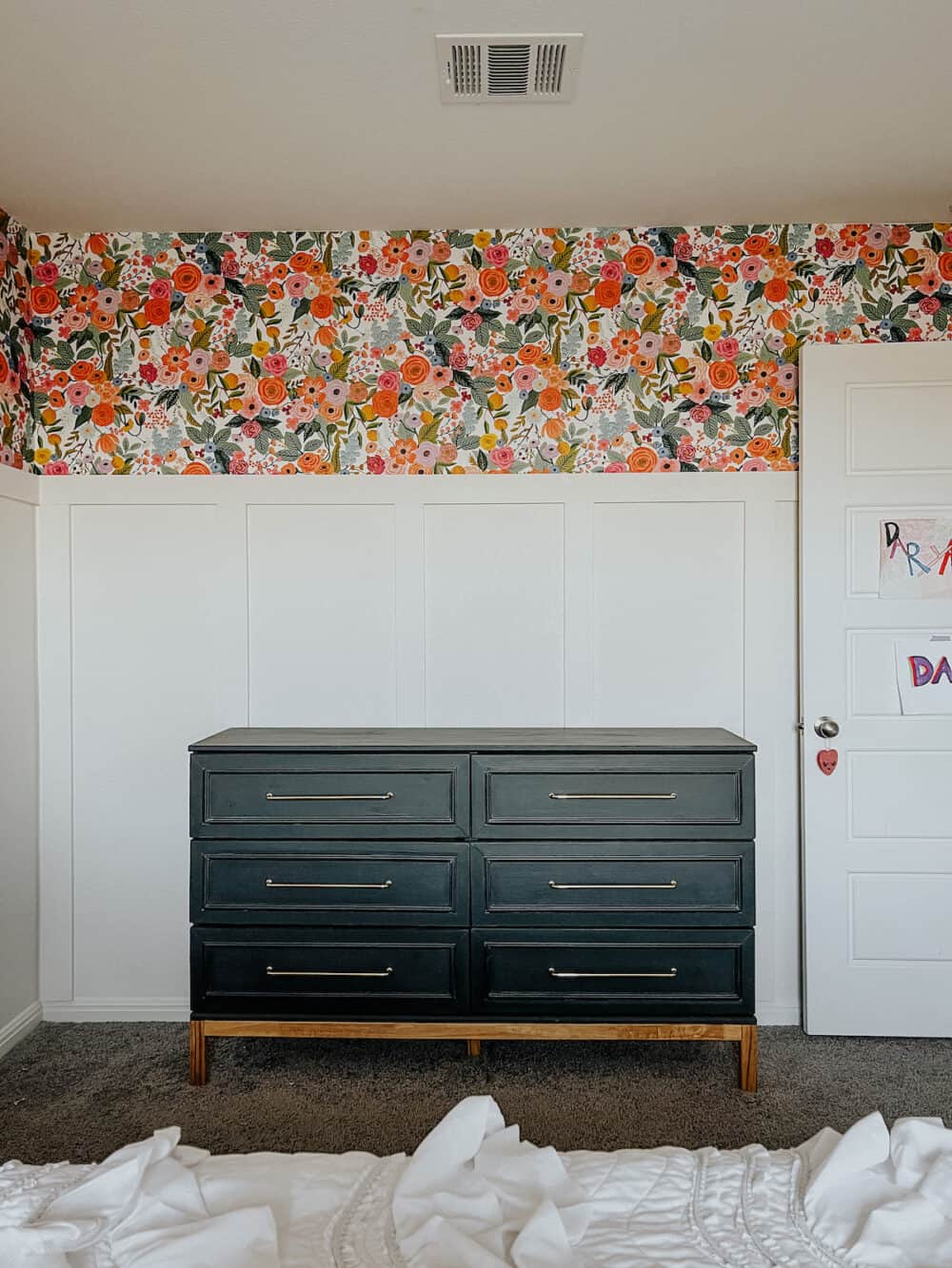 girls' room with floral wallpaper, a board and batten wall, and a black IKEA dresser 