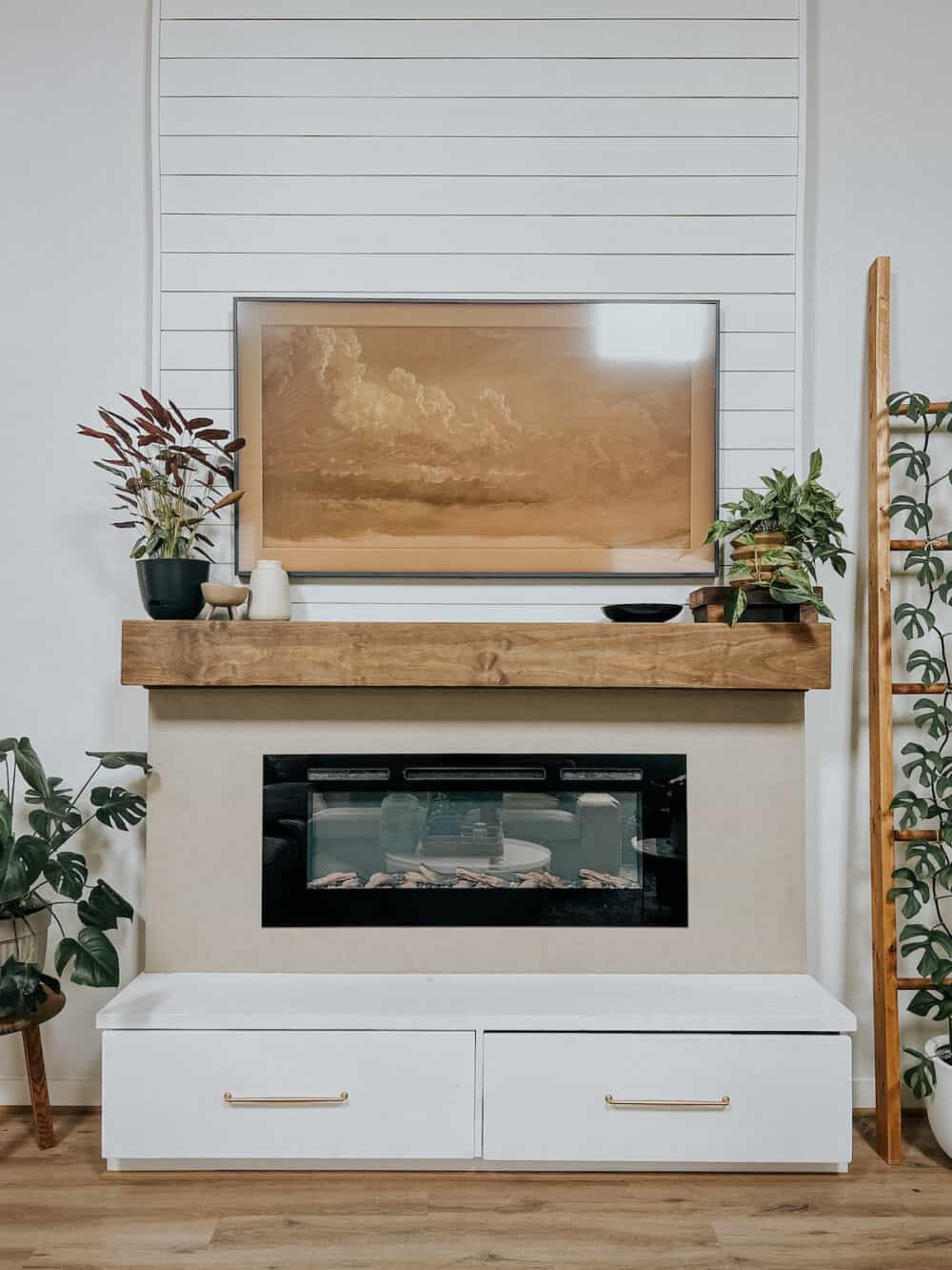 fireplace mantel styled with plants and decor 