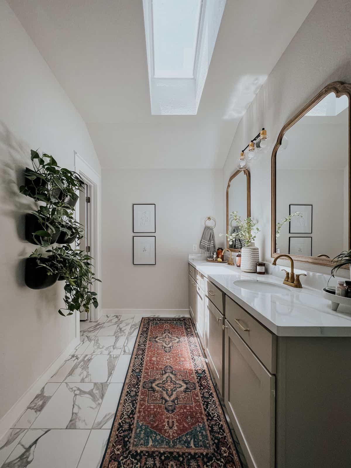 primary bathroom with a skylight and vintage style rug