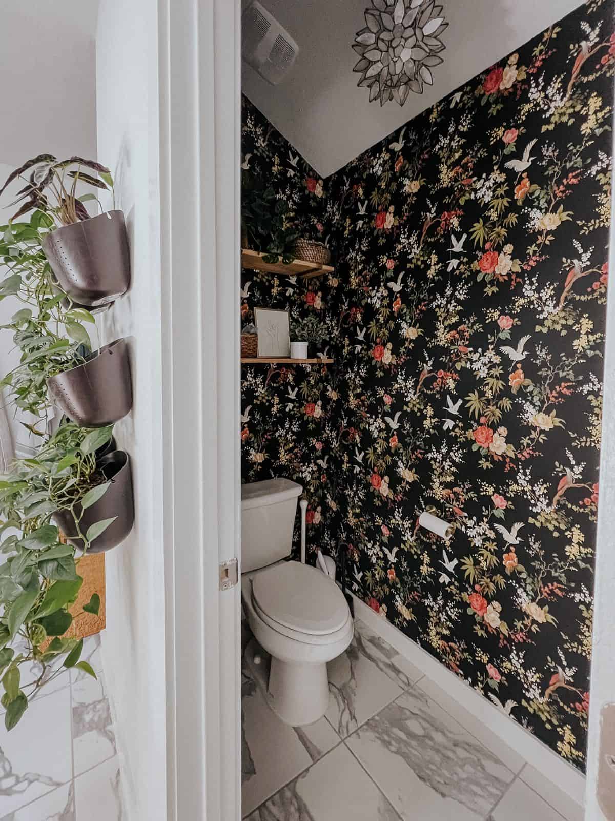 Bathroom water closet with black floral wallpaper