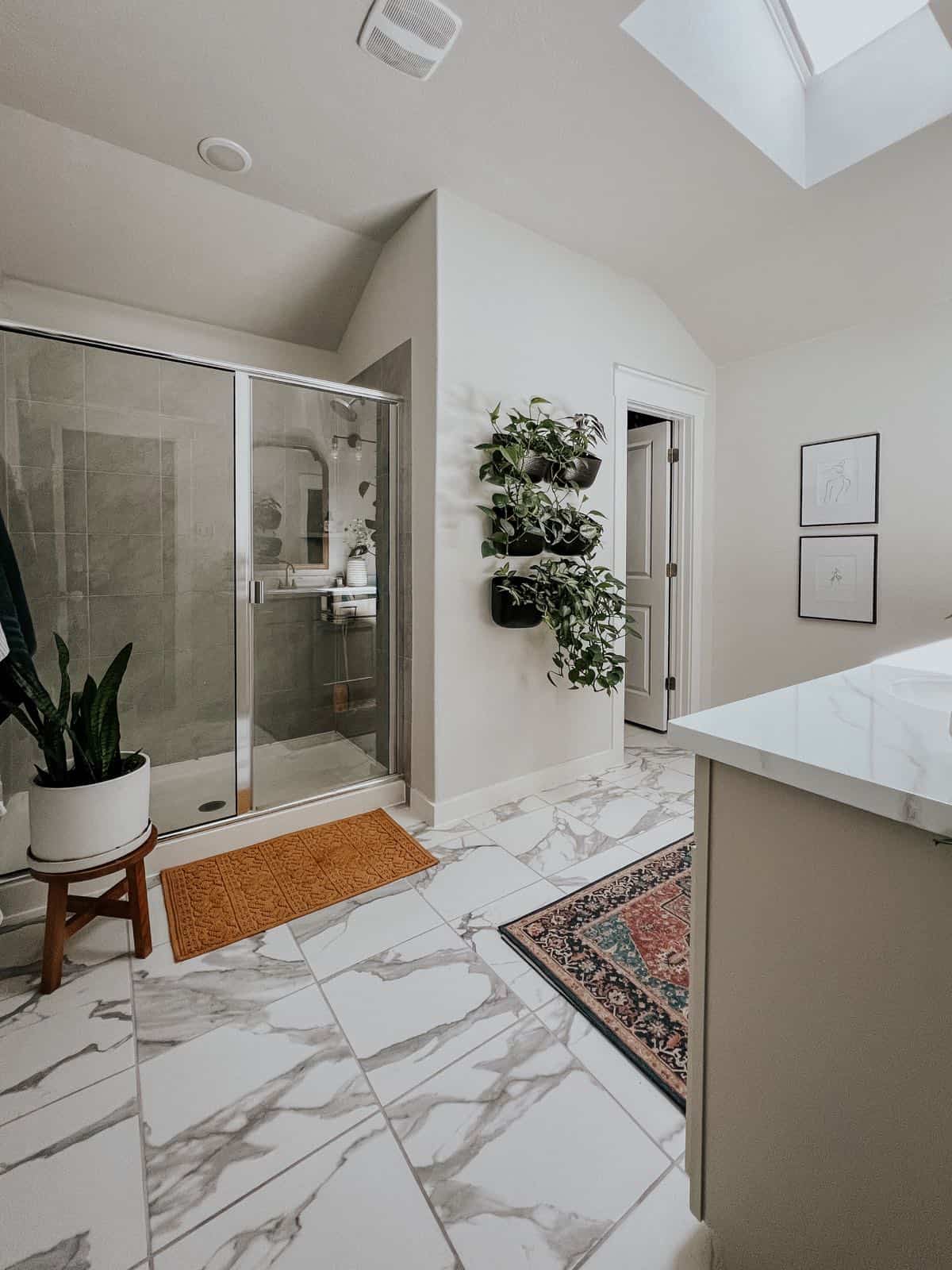 Primary bathroom that is full of light and plants
