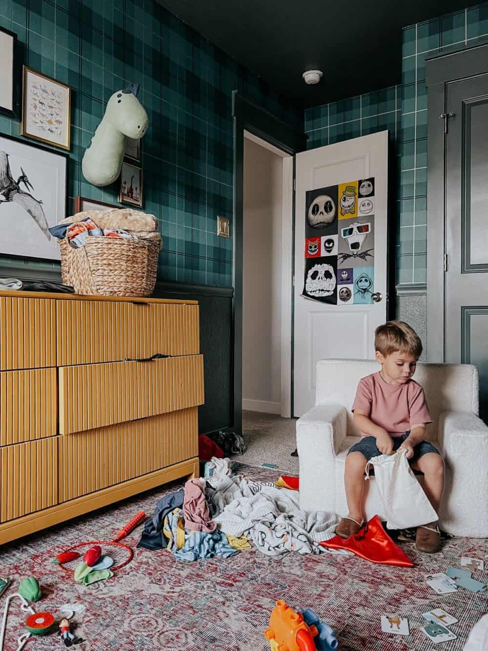 toddler playing in a messy room 