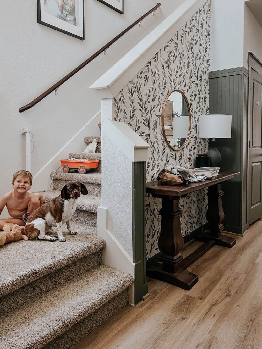 entry with a young boy sitting on the landing with a dog