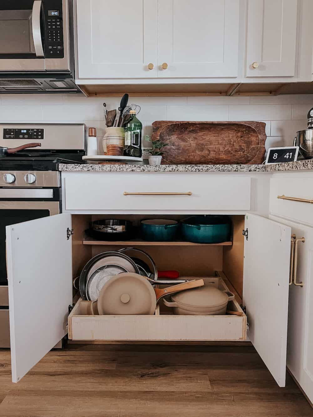 cabinet with pull out drawer to organize pots and pans 