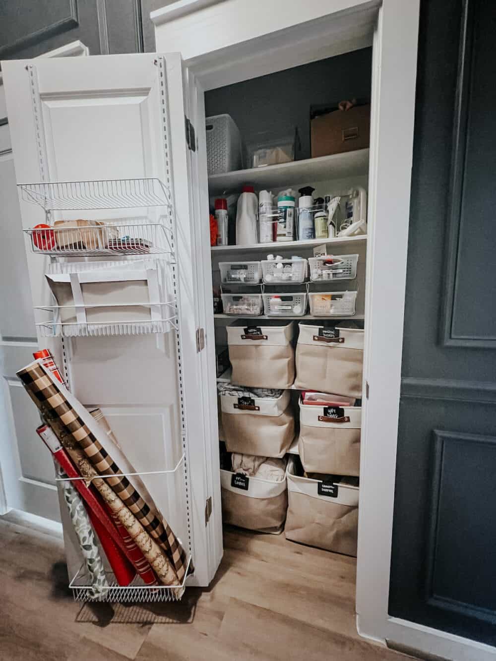 A linen closet organized with large baskets