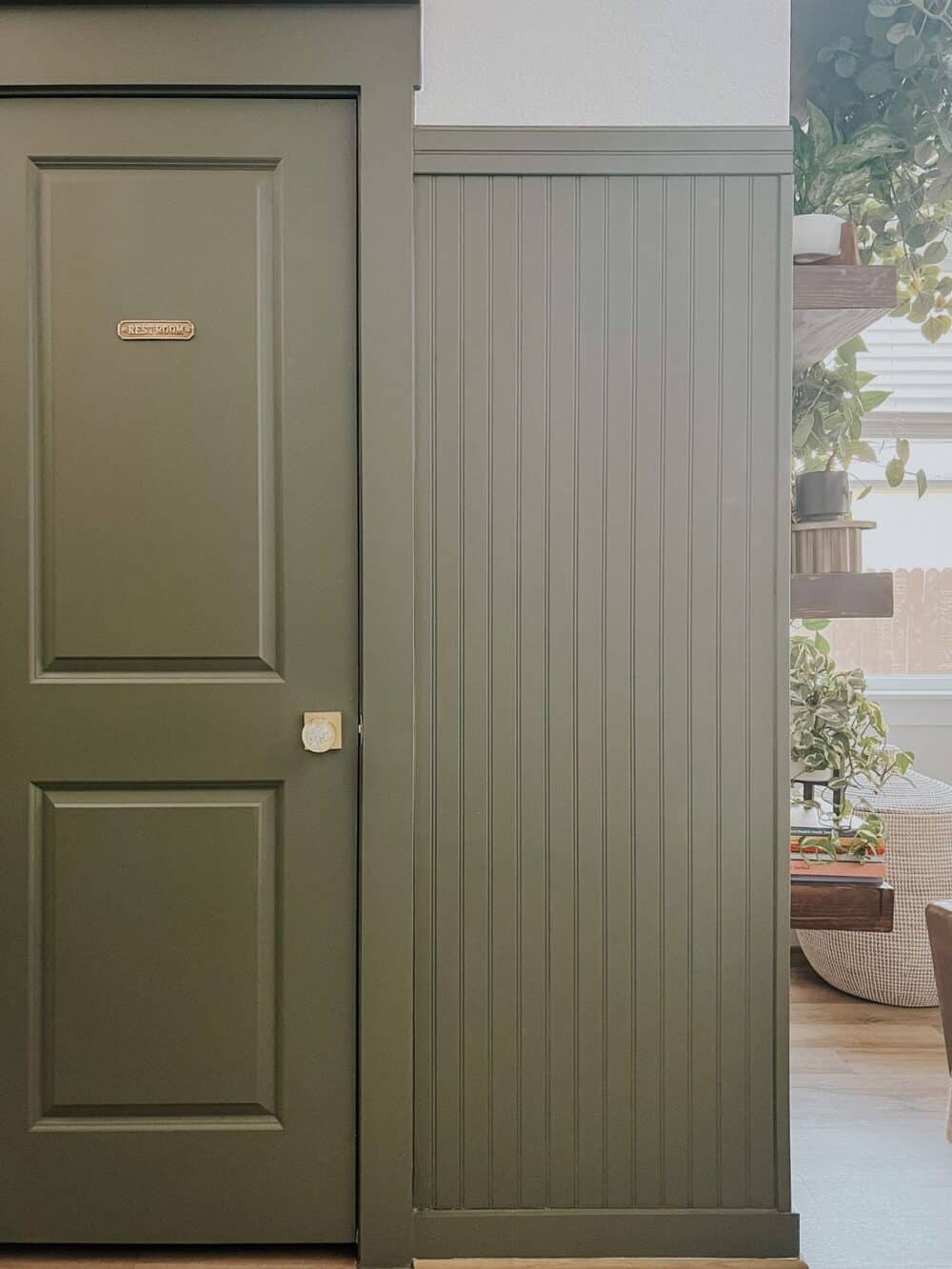 entry with green wall paneling 