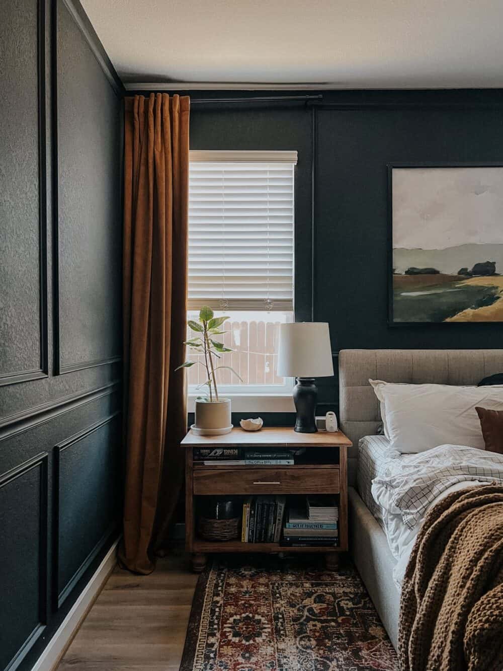 bedroom with dark walls and gold curtains 