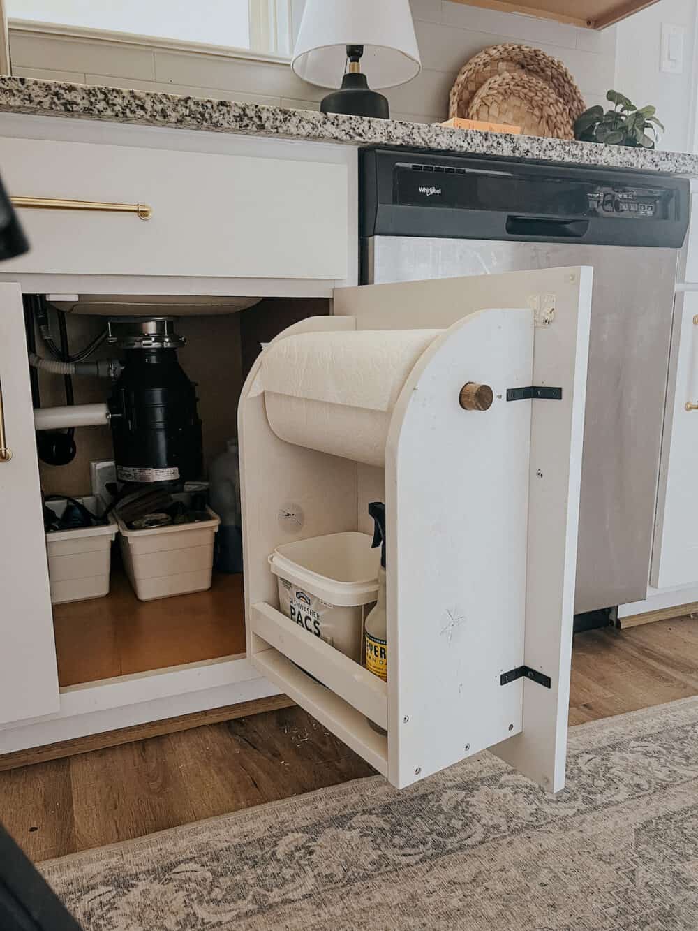 Simple DIY cabinet door organizer hanging in the cabinet under the kitchen sink 