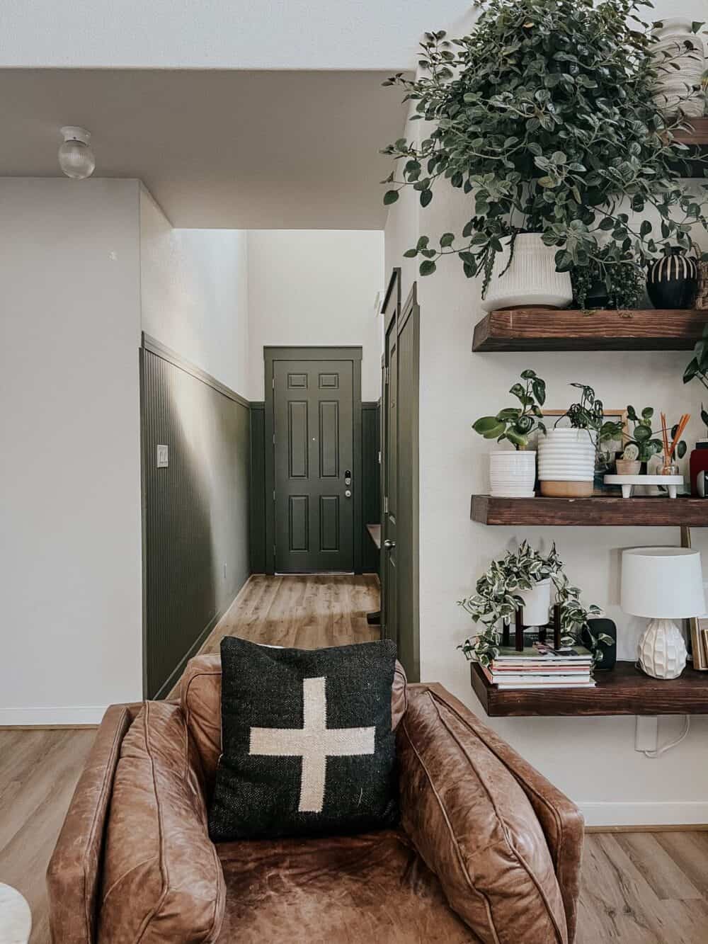 Entry with green paneling and a front door 