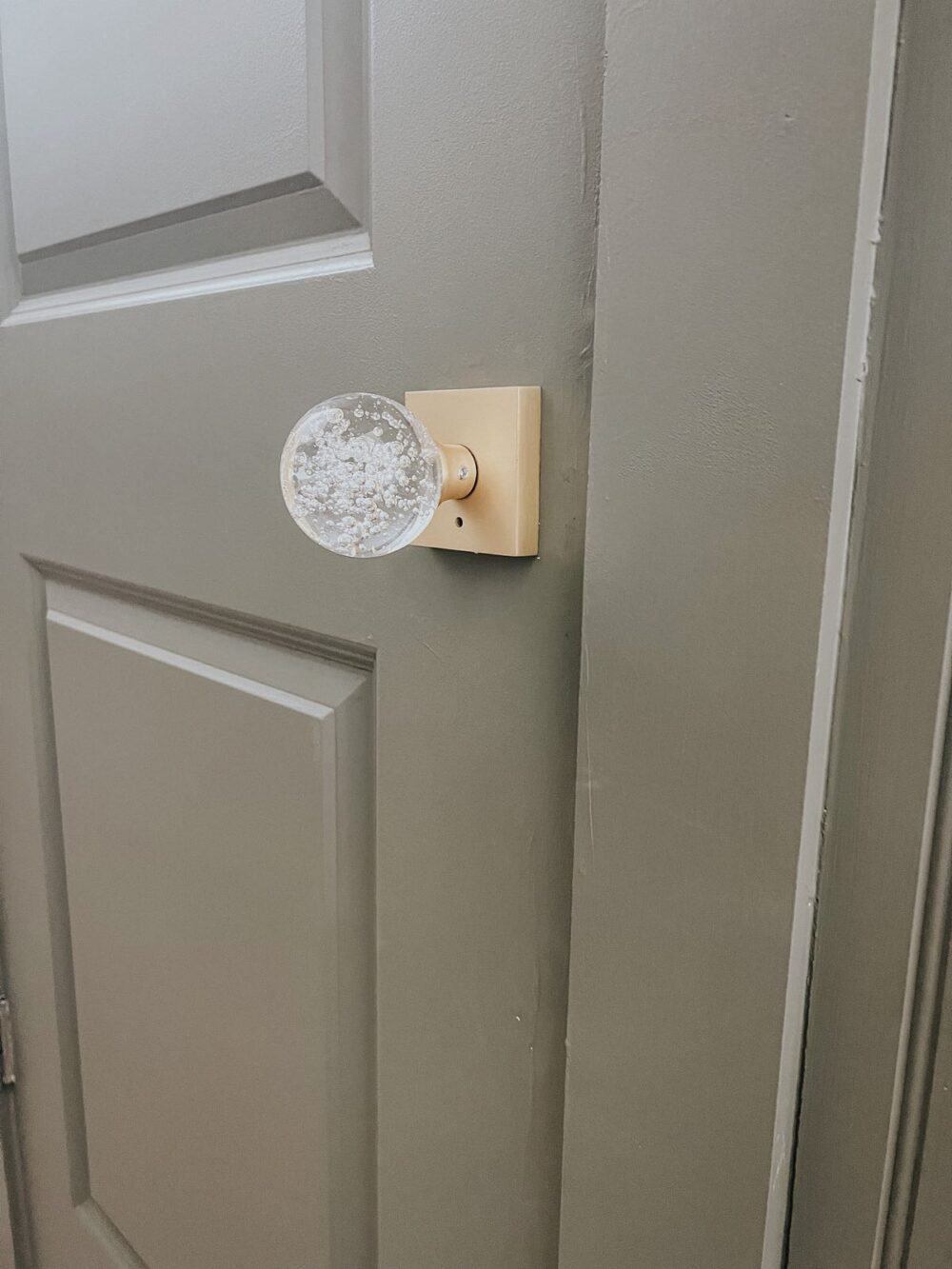 Close up of a crystal door knob on a powder room door 