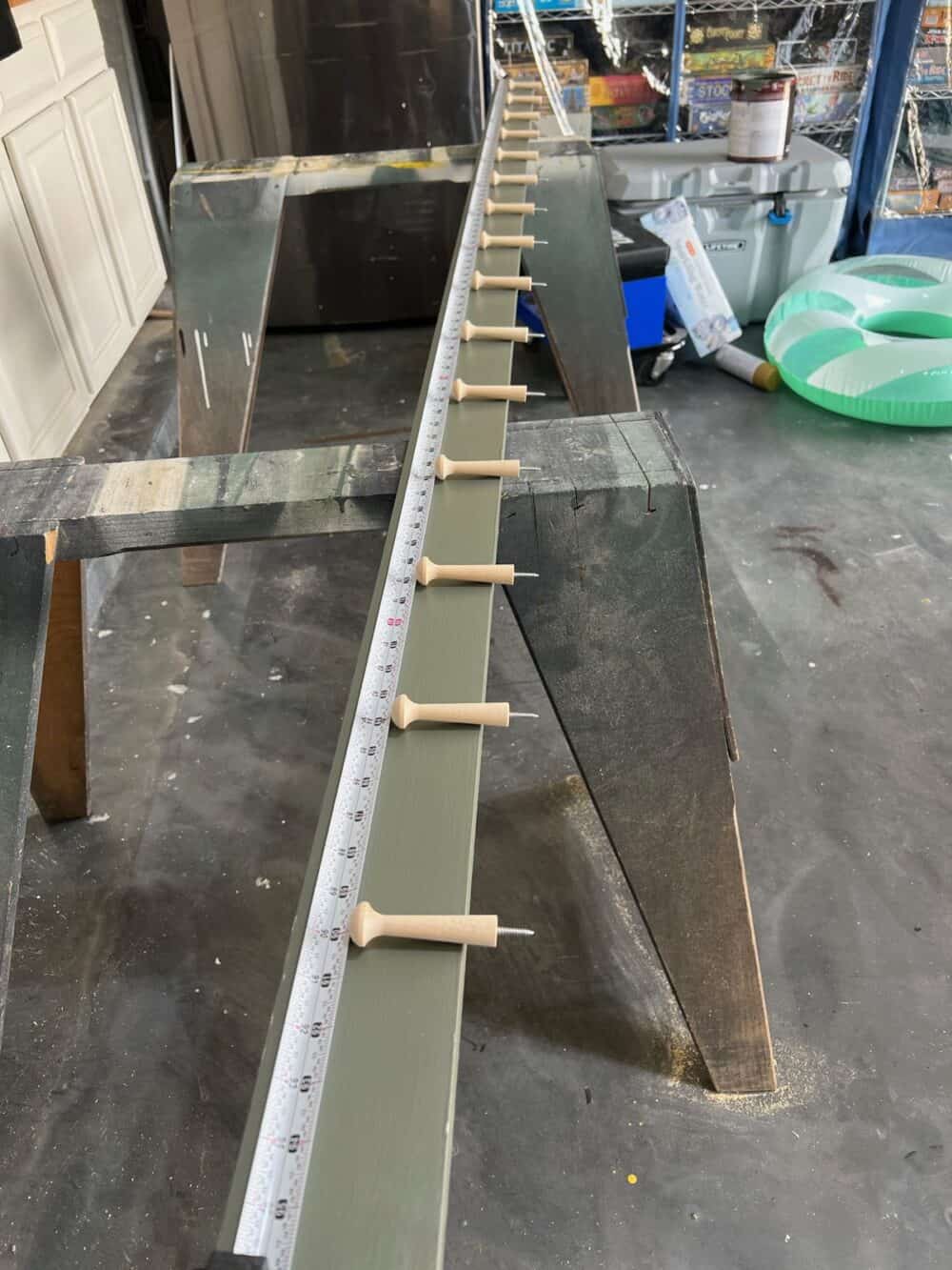 peg rail with hooks on the board ready to be installed 