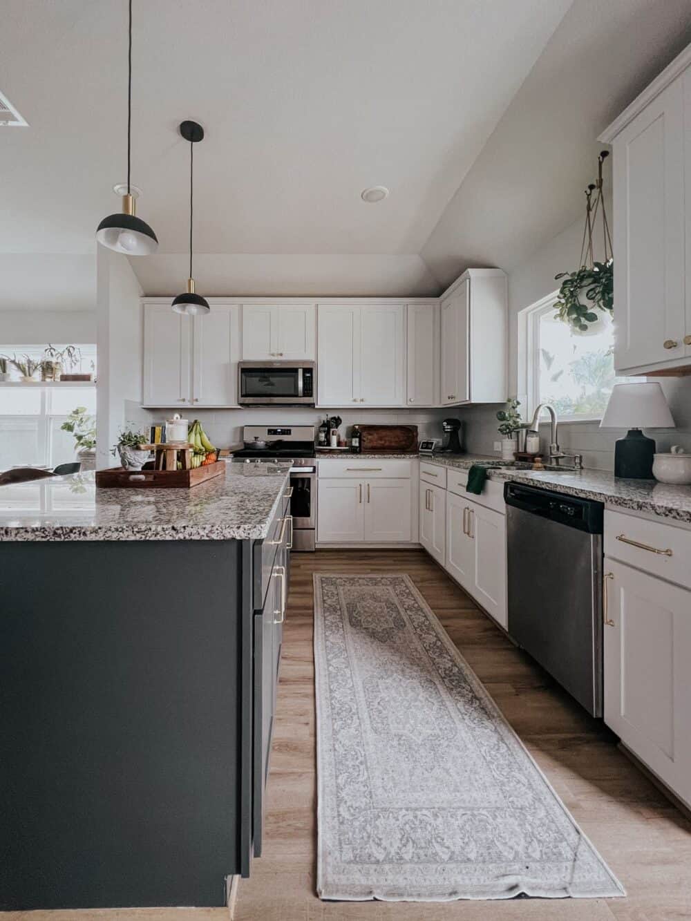 kitchen with white perimeter cabinets and an island painted Carbon Copy by Behr