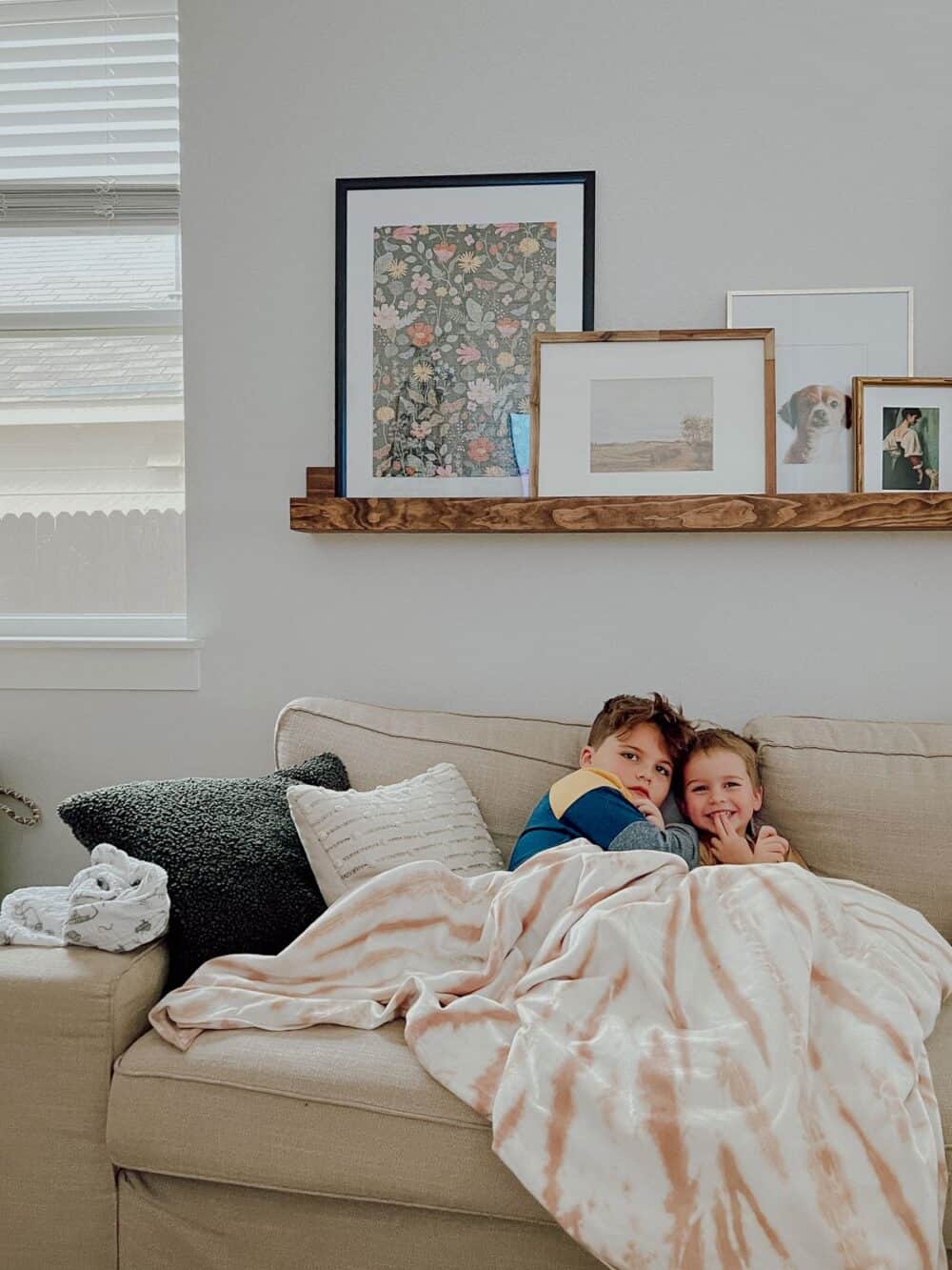 two boys cuddling on a couch 