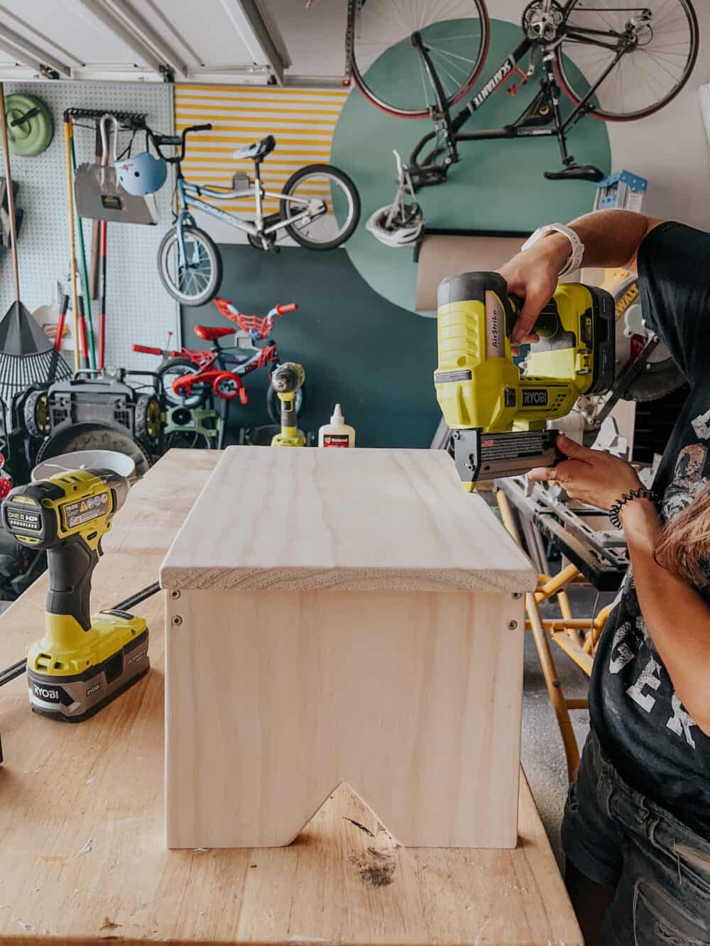 Woman attaching top to wooden step stool 