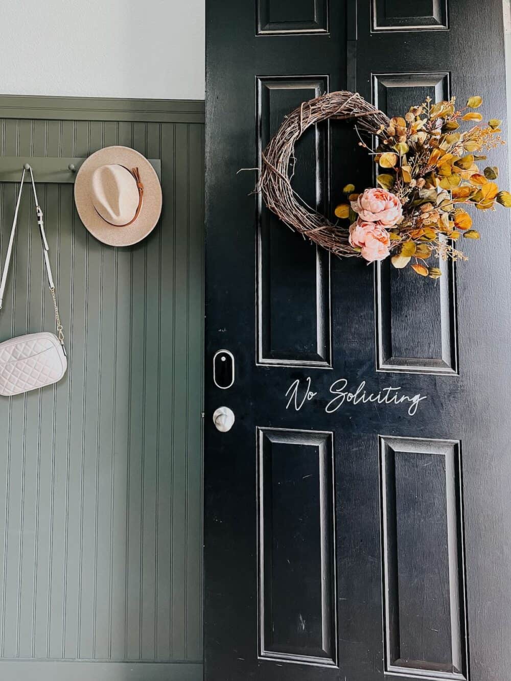 open front door with a fall wreath hanging on it 