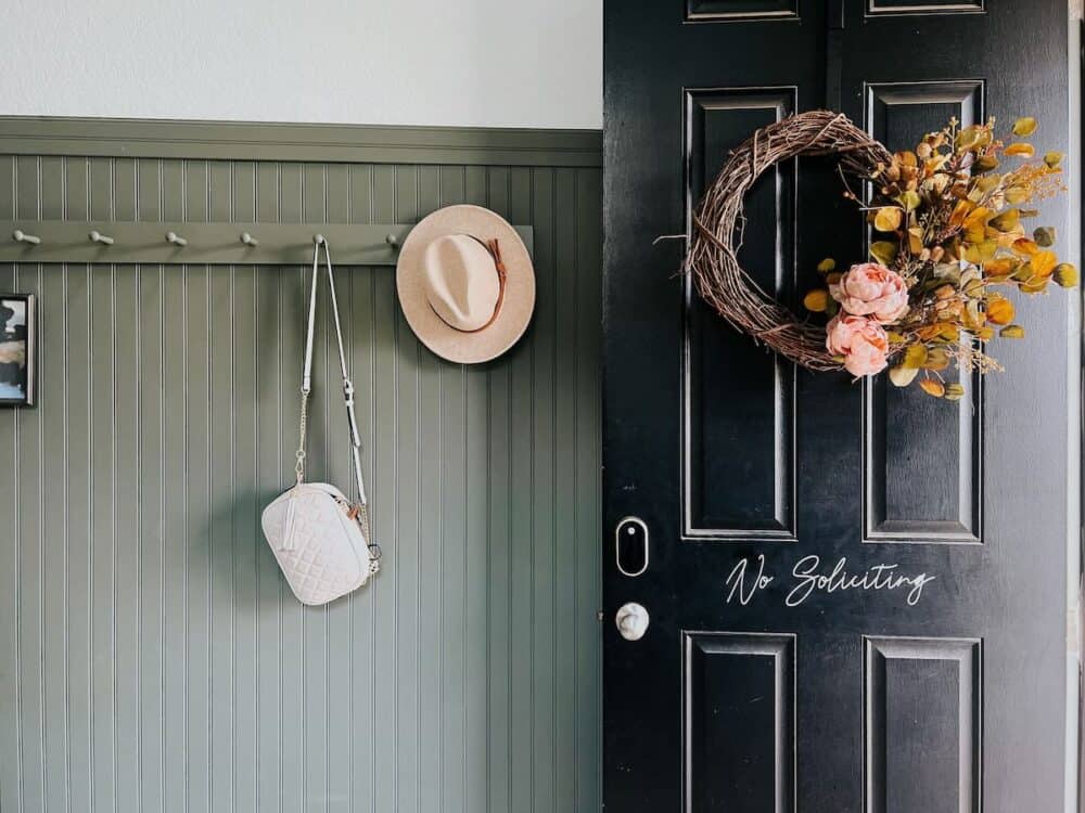 diy fall wreath hanging on a black door 