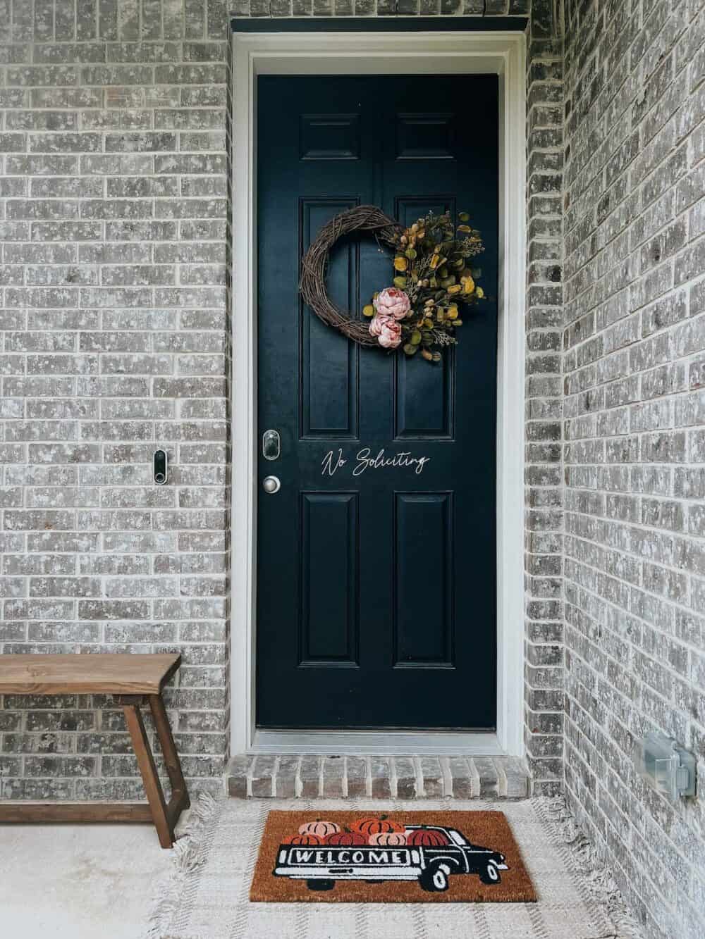 small front porch with a diy fall wreath hanging on the door 