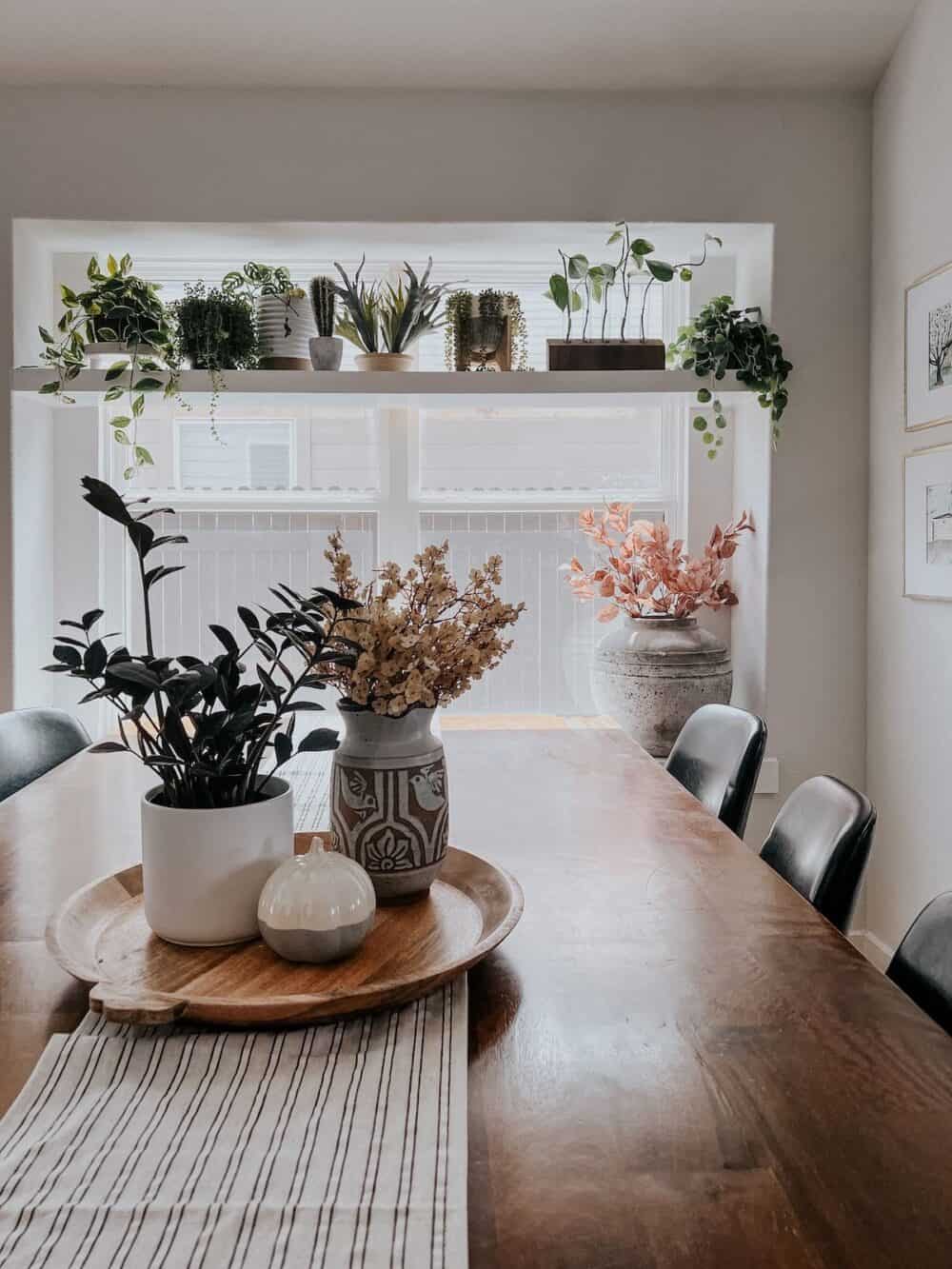 faux fall florals on a table in a pitcher 