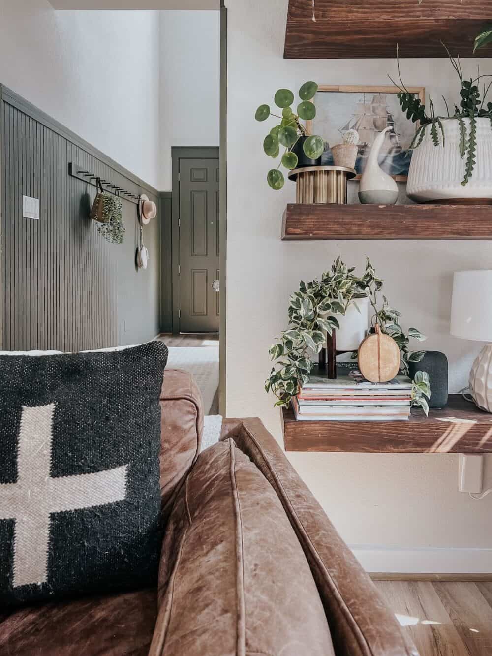 floating shelves with plants and a couple of faux gourds 