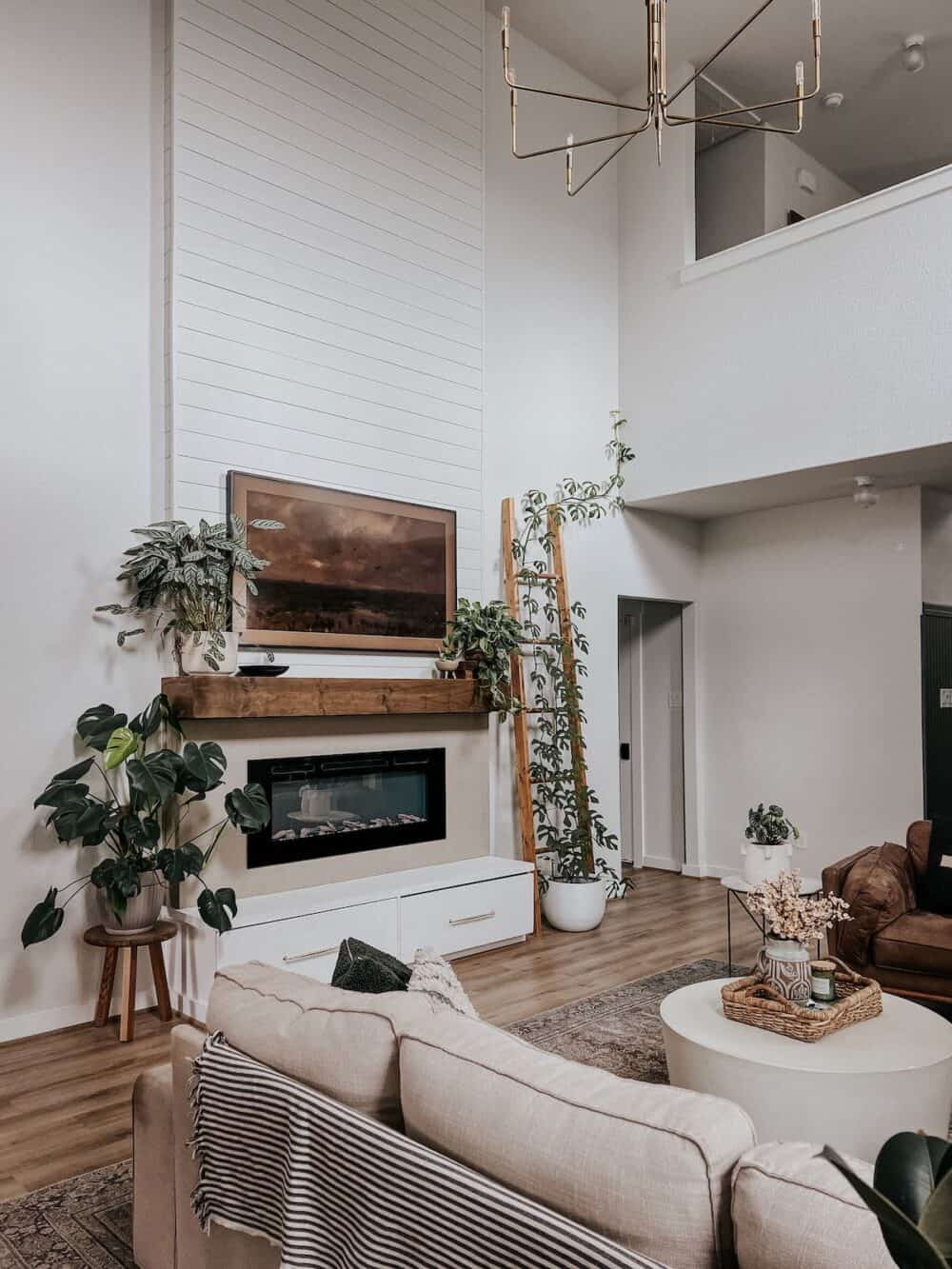 Living room with a tall shiplap fireplace 