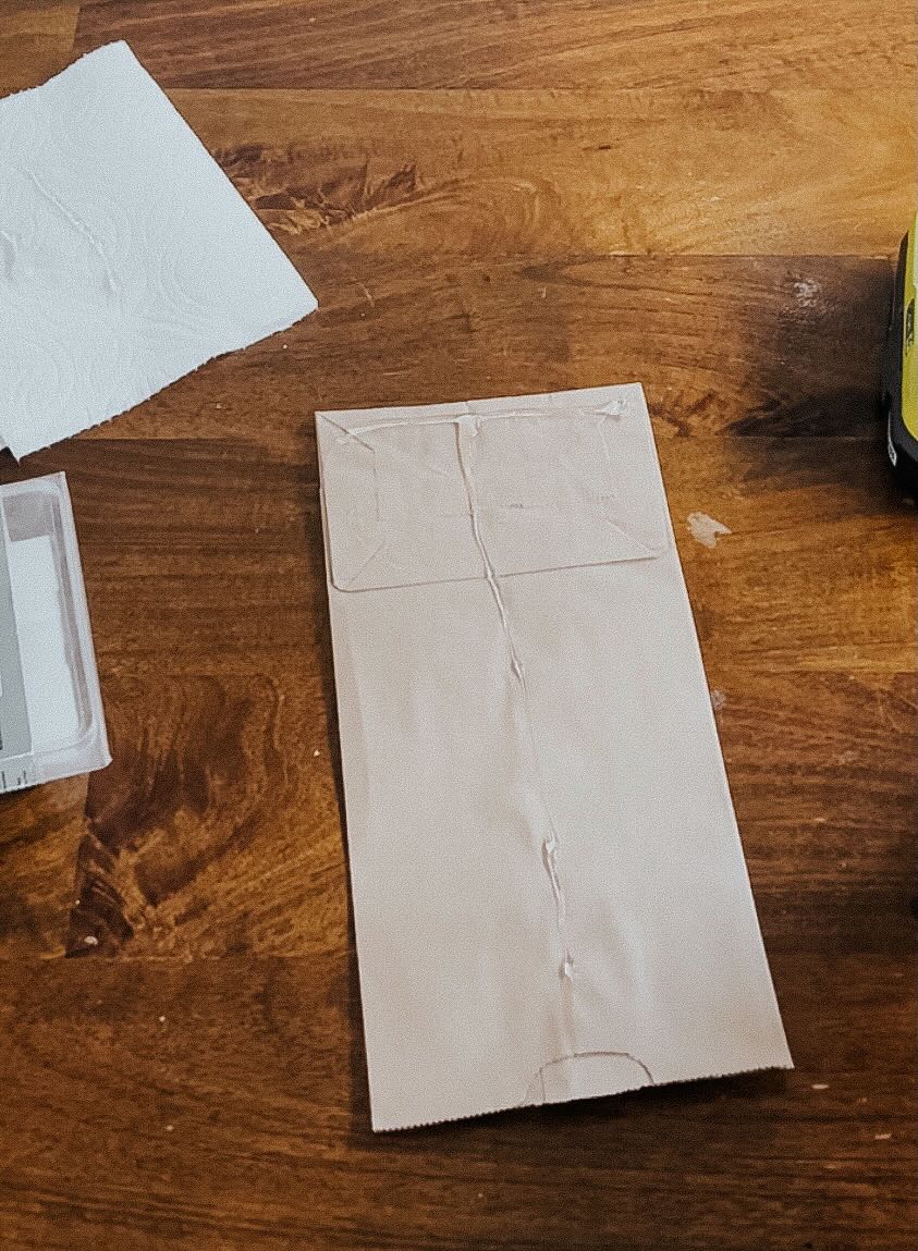 paper bag being glued to create snowflake 