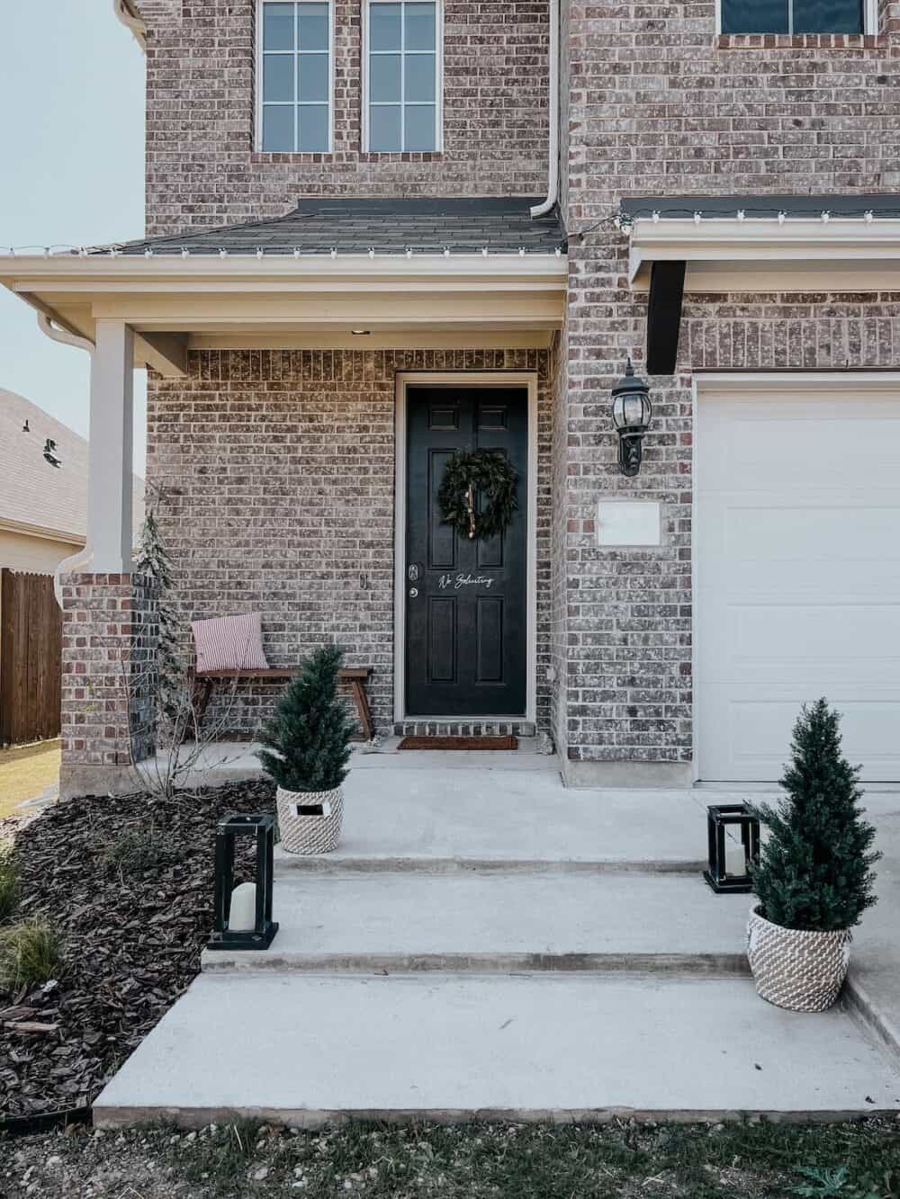 Front entry of a suburban home decorated for Christmas