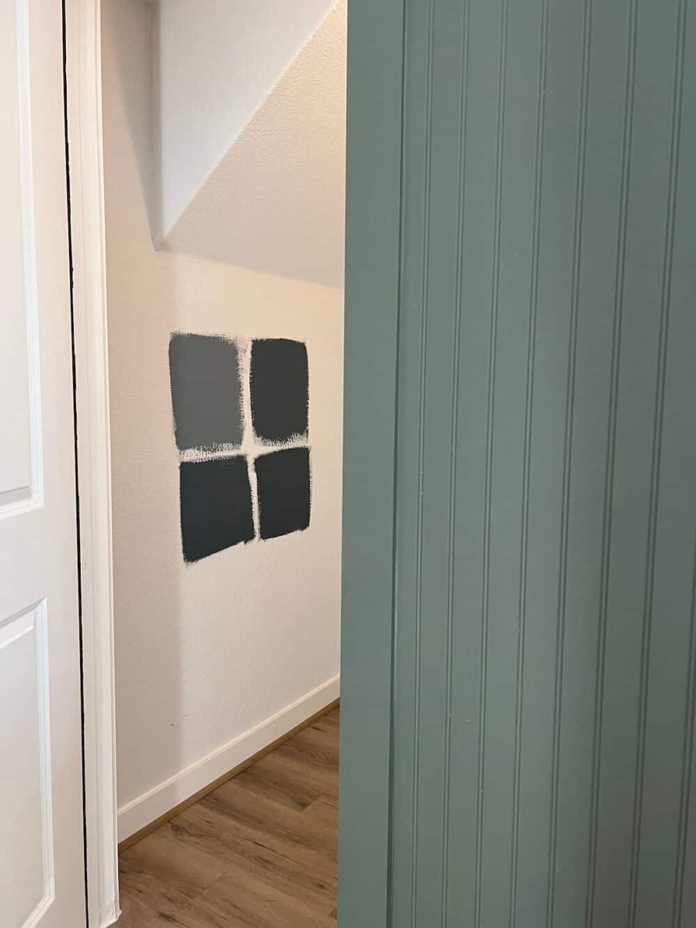 paint samples on the wall of a powder room