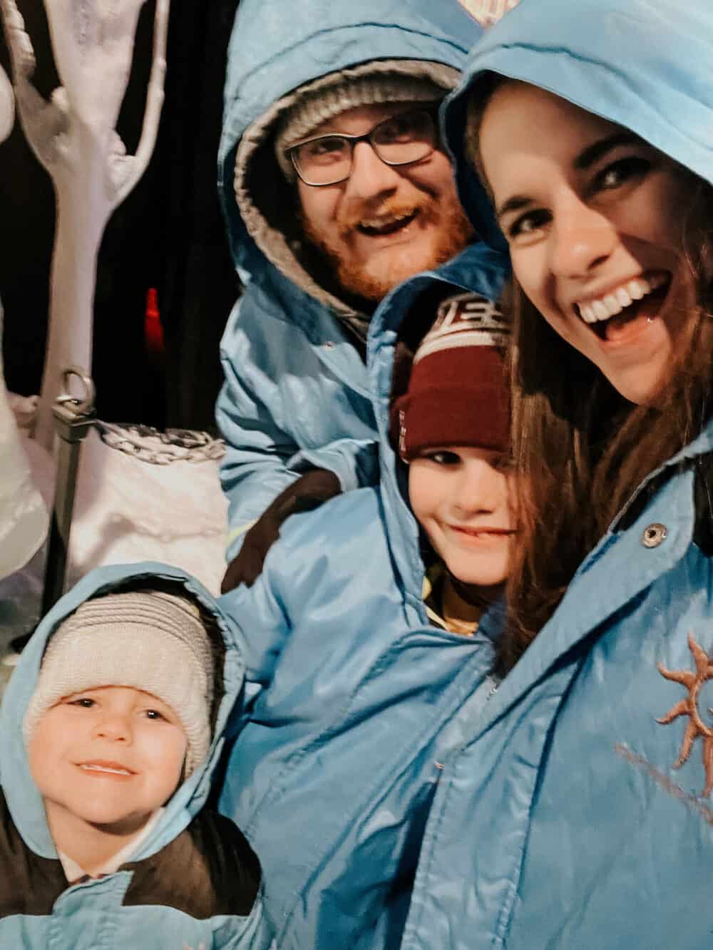 family posing for a picture in Gaylord blue parkas 