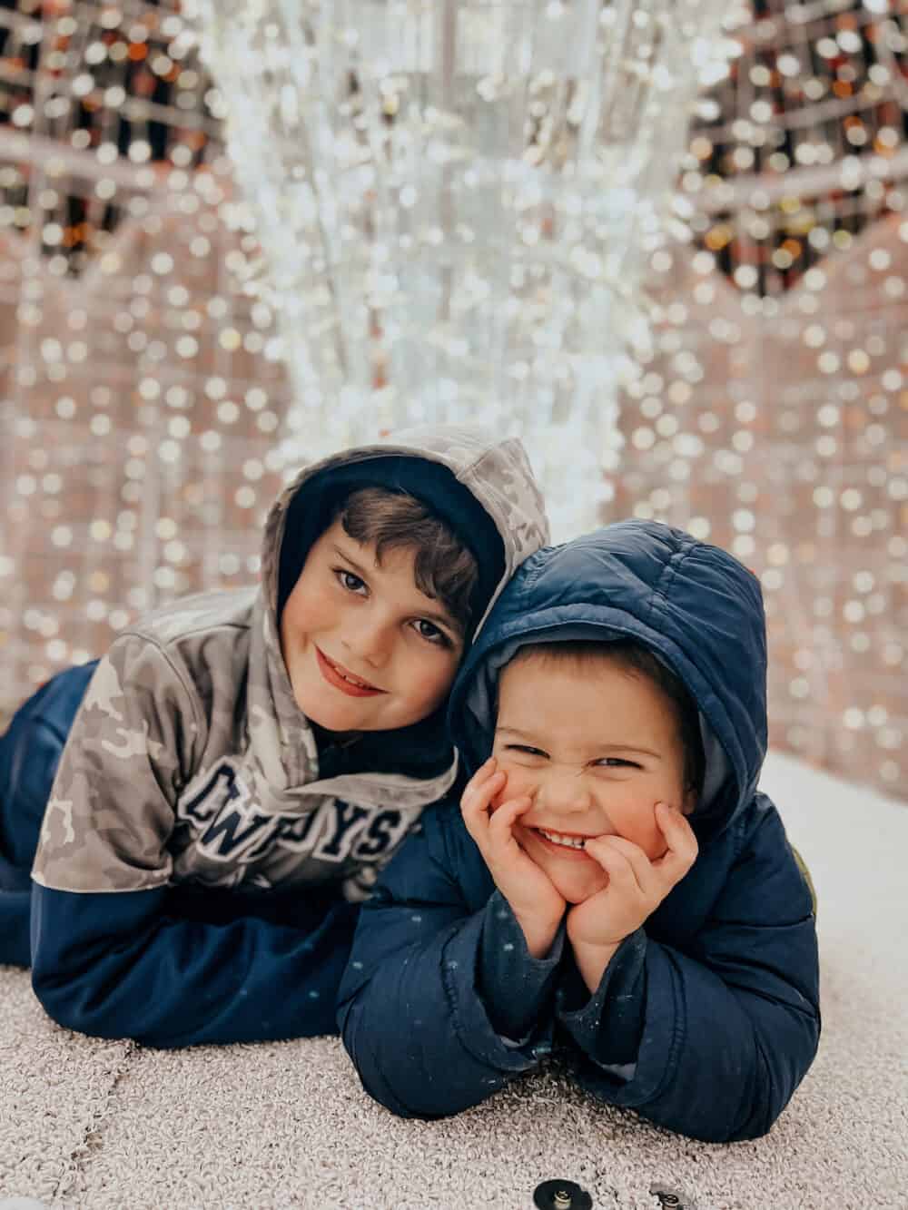 Two boys posing on Christmas trail of lights at Gaylord Texan