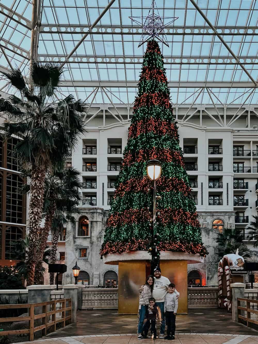 family posing in front of the Christmas tree at the Gaylord Texan Resort