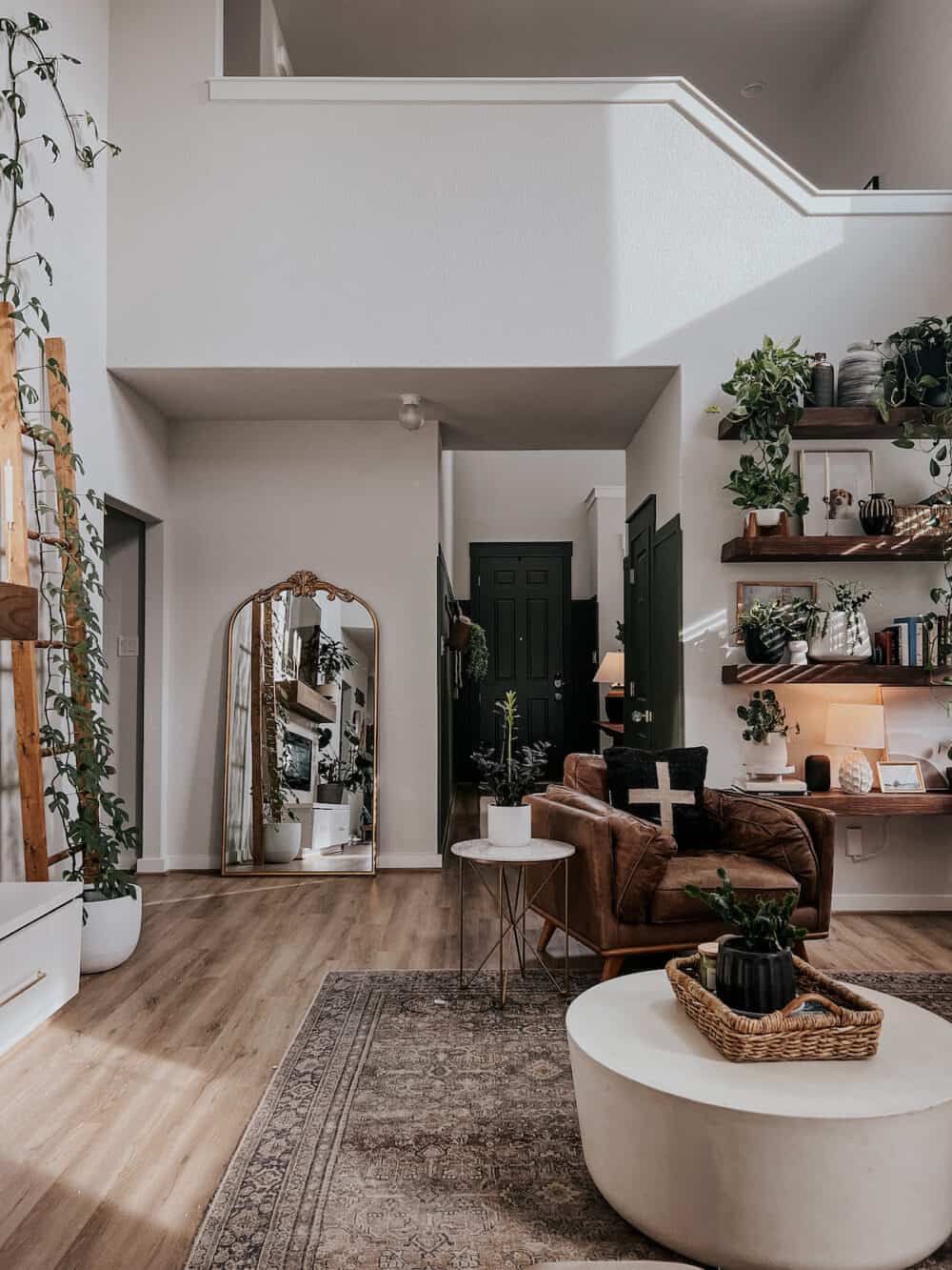 open living room with a tall gold mirror 