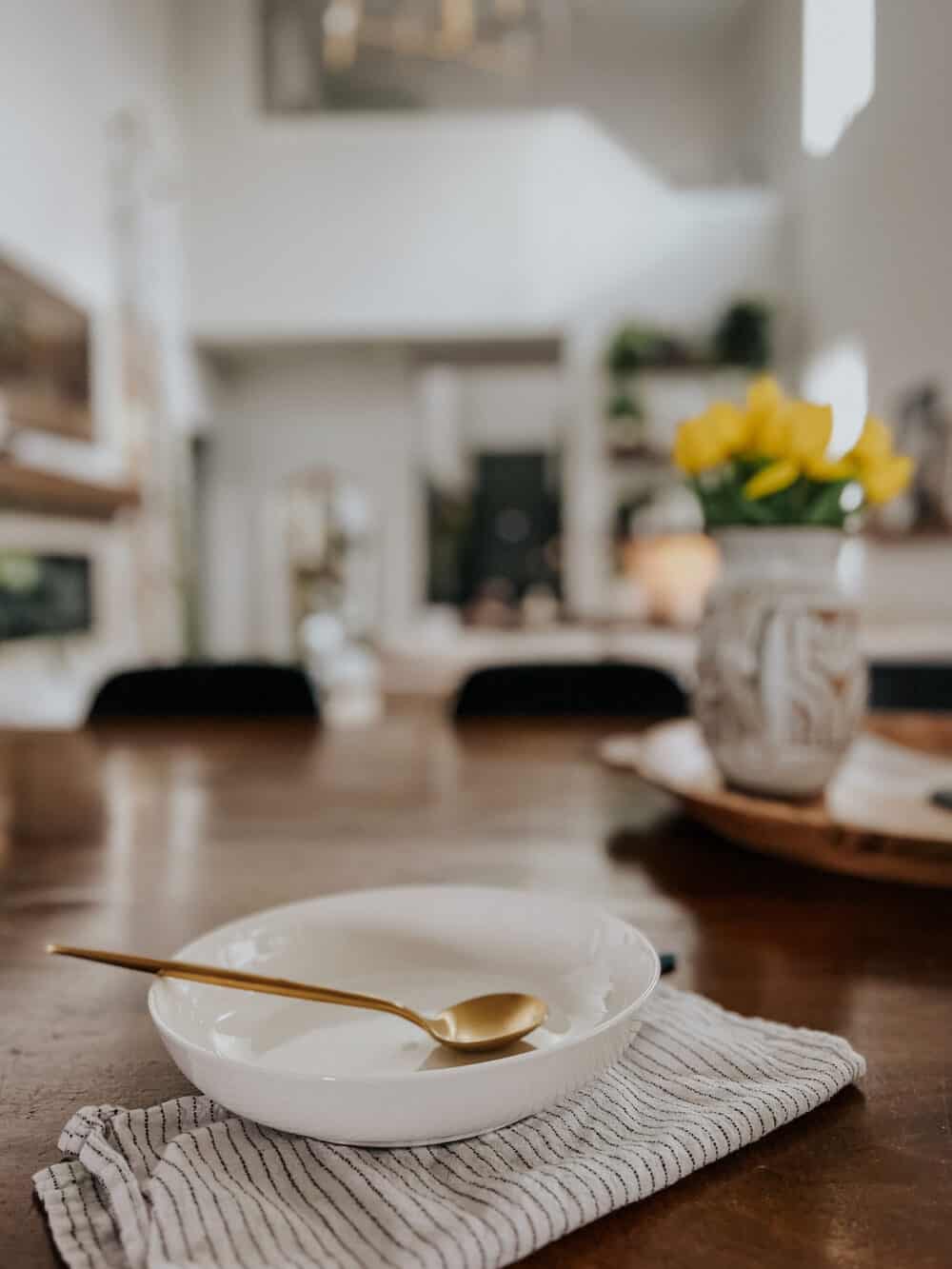 close up of a beautiful white low bowl with a gold spoon