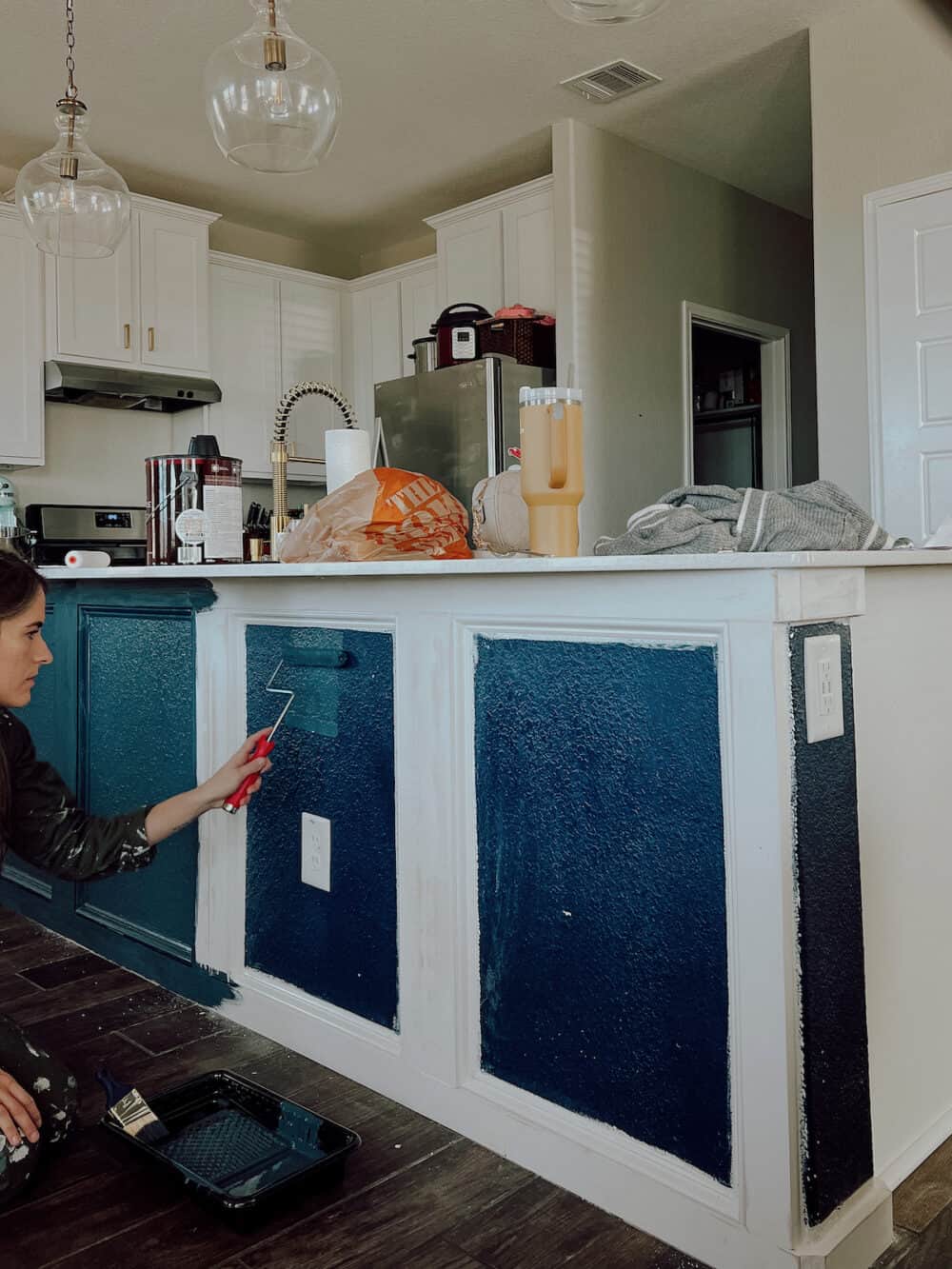 Woman painting a kitchen island