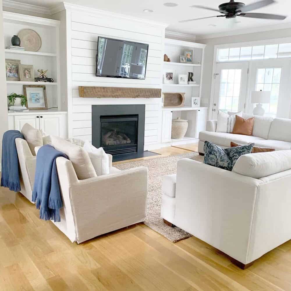 living room with a shiplap fireplace and open shelving 