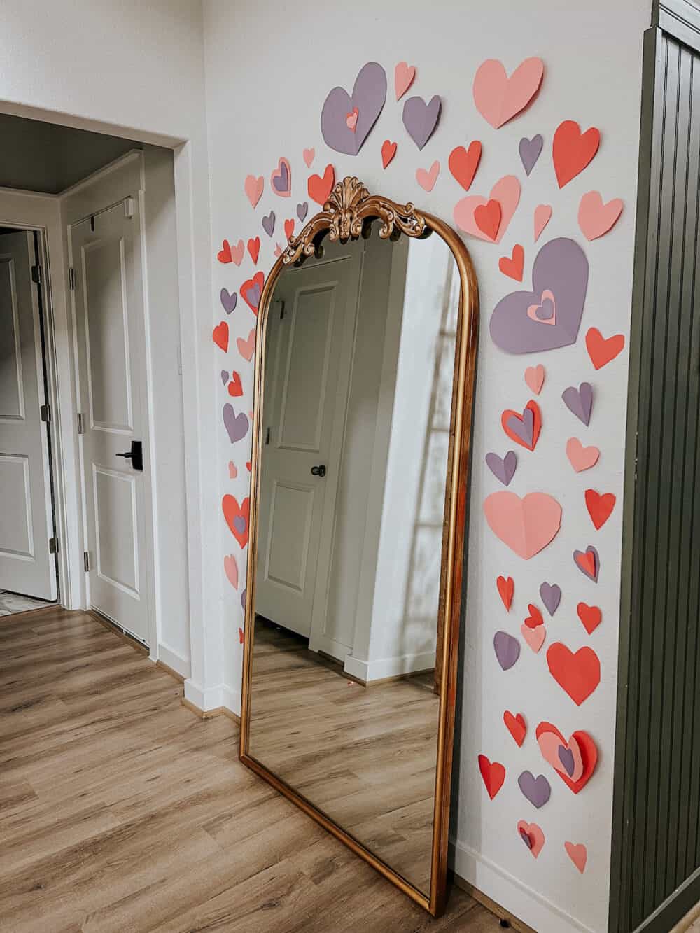 Heart collage on a wall around a mirror 