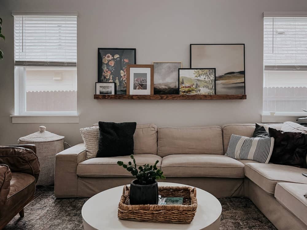 Living room with a DIY art ledge and a framed puzzle 