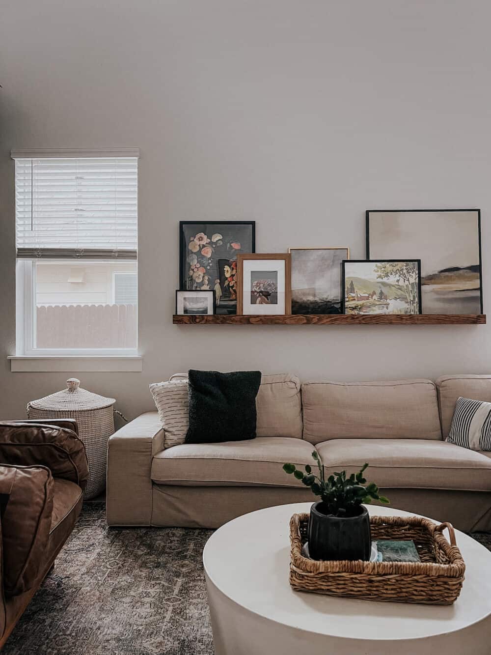 living room with a large art ledge, with a framed puzzle included among the art 