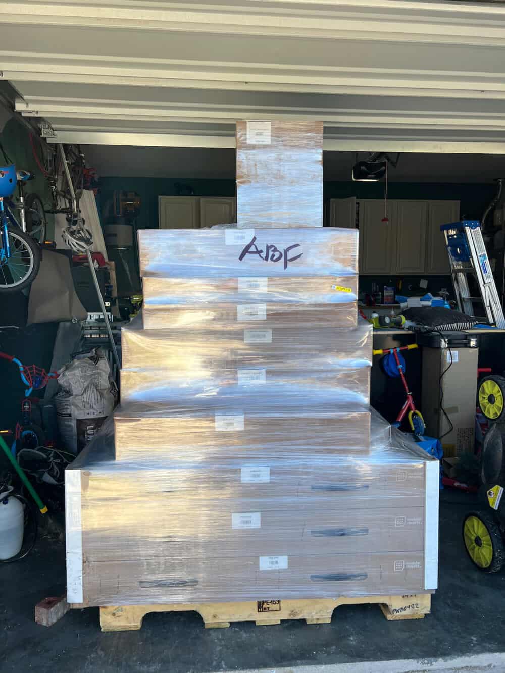 Large stack of boxes on a pallet in a garage 