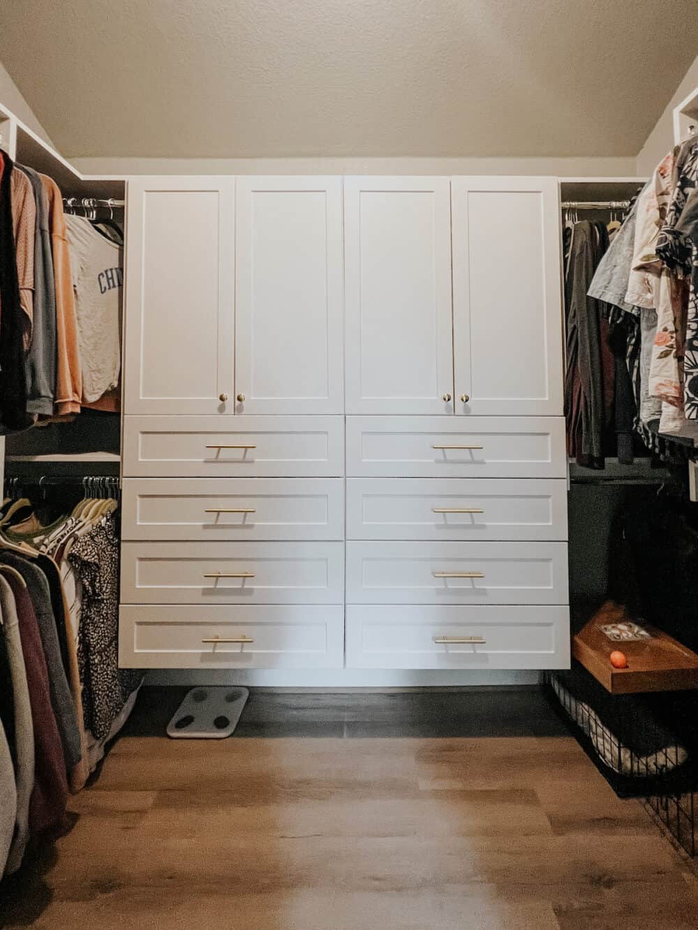master closet with built in shelving and drawers 