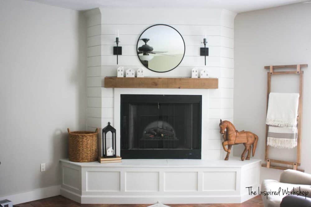 DIY shiplap fireplace in the corner of a room 